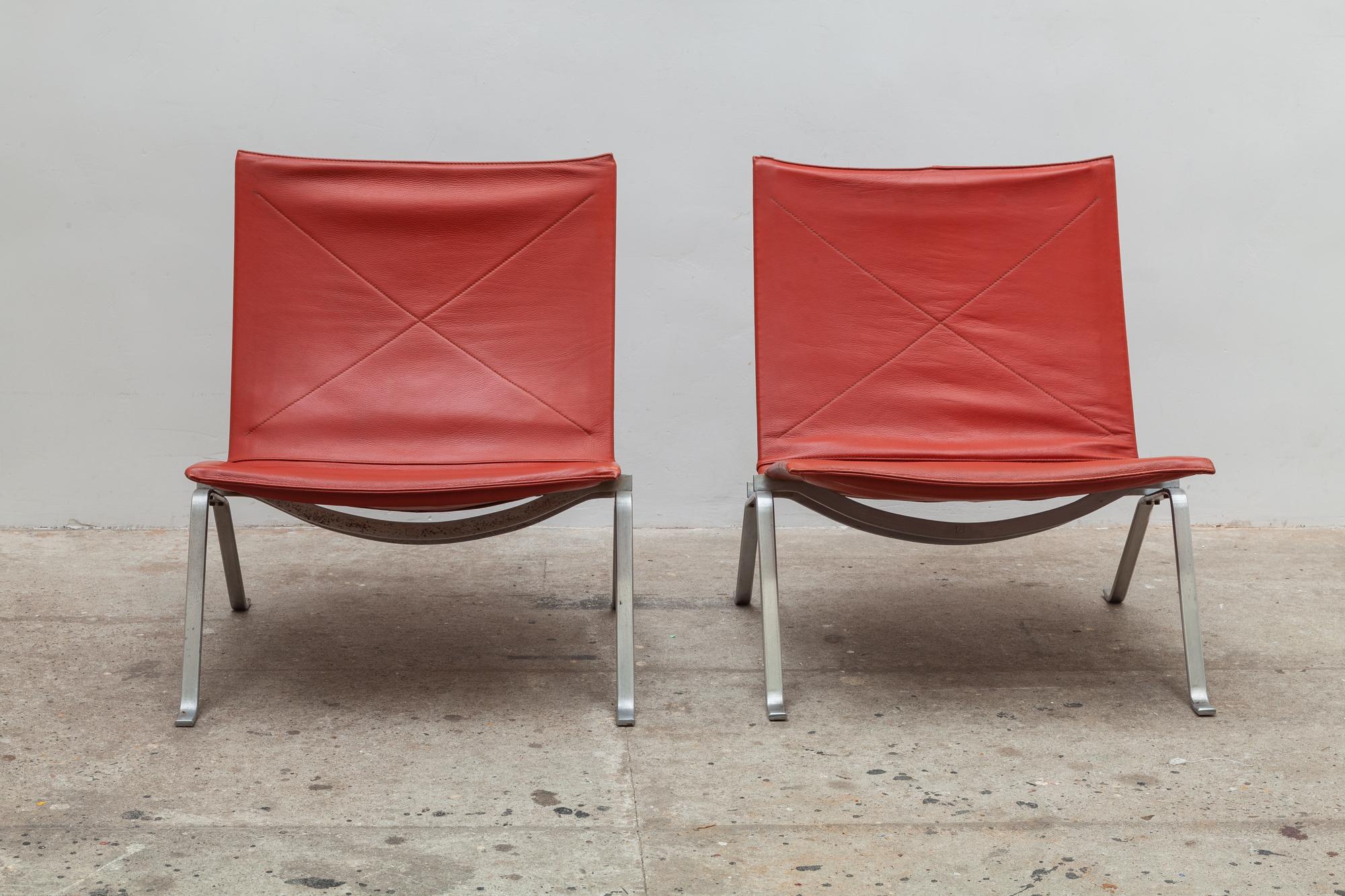 A pair of PK 22 lounge chairs by Poul Kjaerholm, Denmark. Designed in 1956 and produced by E. Kold Christensen. Brushed steel frame covered with durable oxblood leather upholstery. Stamped with the EKC Denmark logo.
Dimensions: 62 W x 70 H x 62 D