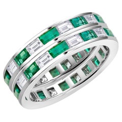 Pair of Platinum Baguette Shaped Emerald and Diamond Eternity Bands