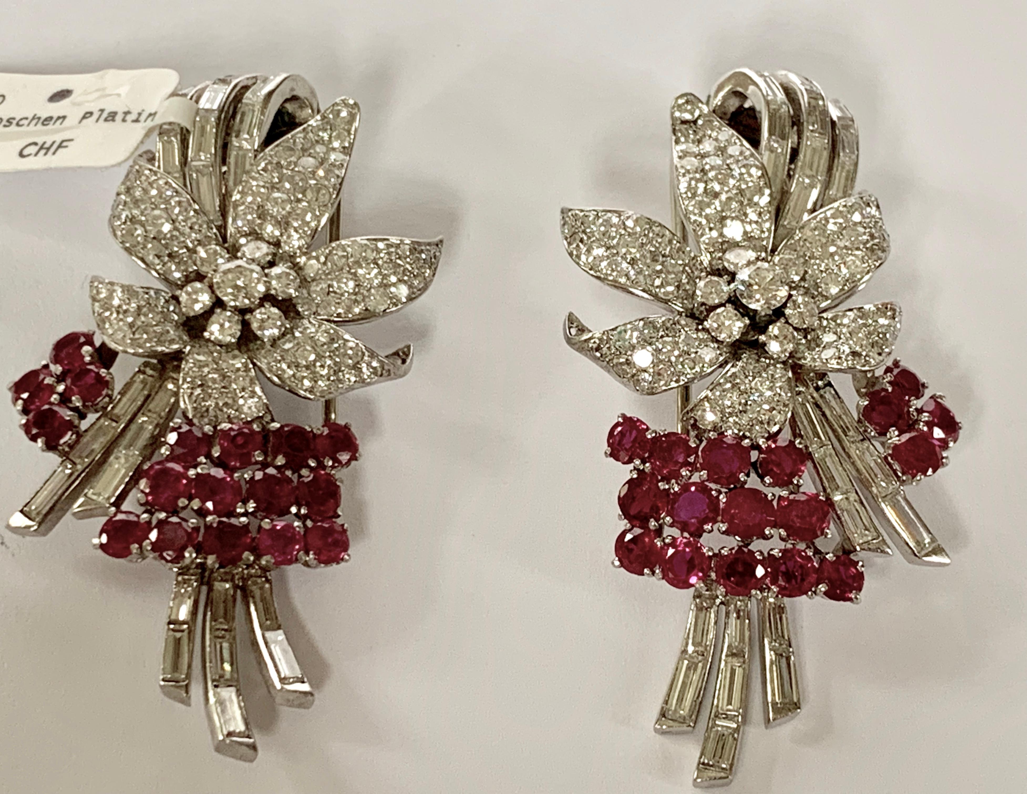 A pair of  Retro platinum clips with rubies and diamonds. The pair of clips have 17 rubies with an approximate total weight of 2.50 carats, 22 baguette diamonds of circa 2.20 ct,  and various European-cut diamonds  and resort diamonds with an