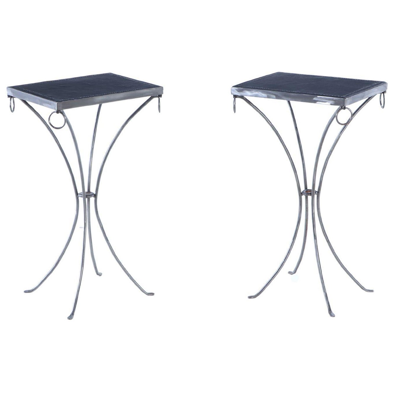 A pair of polished iron drinks tables.