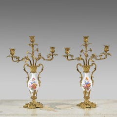 A pair of porcelain and gilt brass candelabra by Thomas Abbott