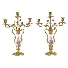A pair of porcelain and gilt brass candelabra by Thomas Abbott