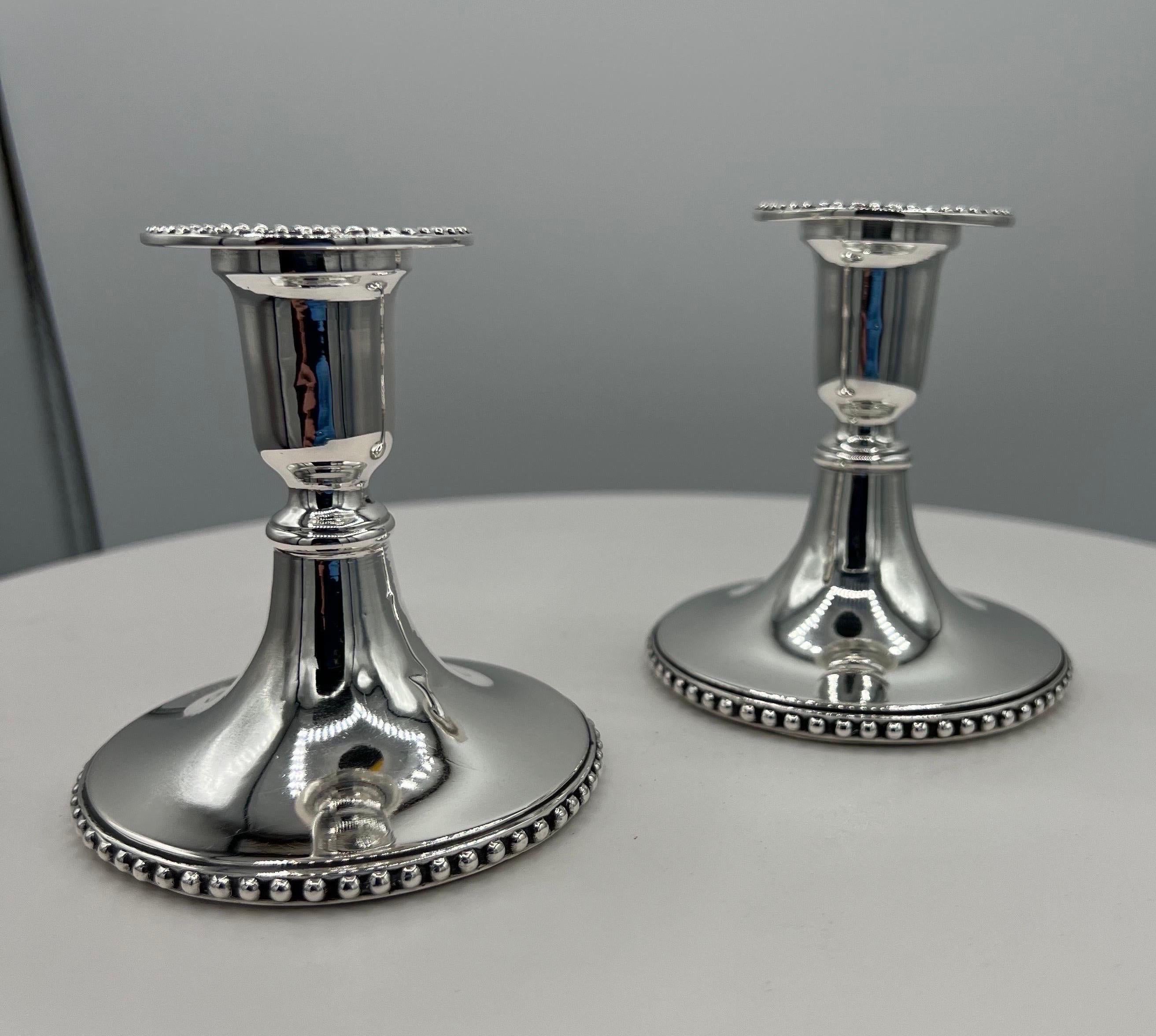 A Pair of Portuguese Sterling Silver Candle Sticks
Marked A. D'Abreu.