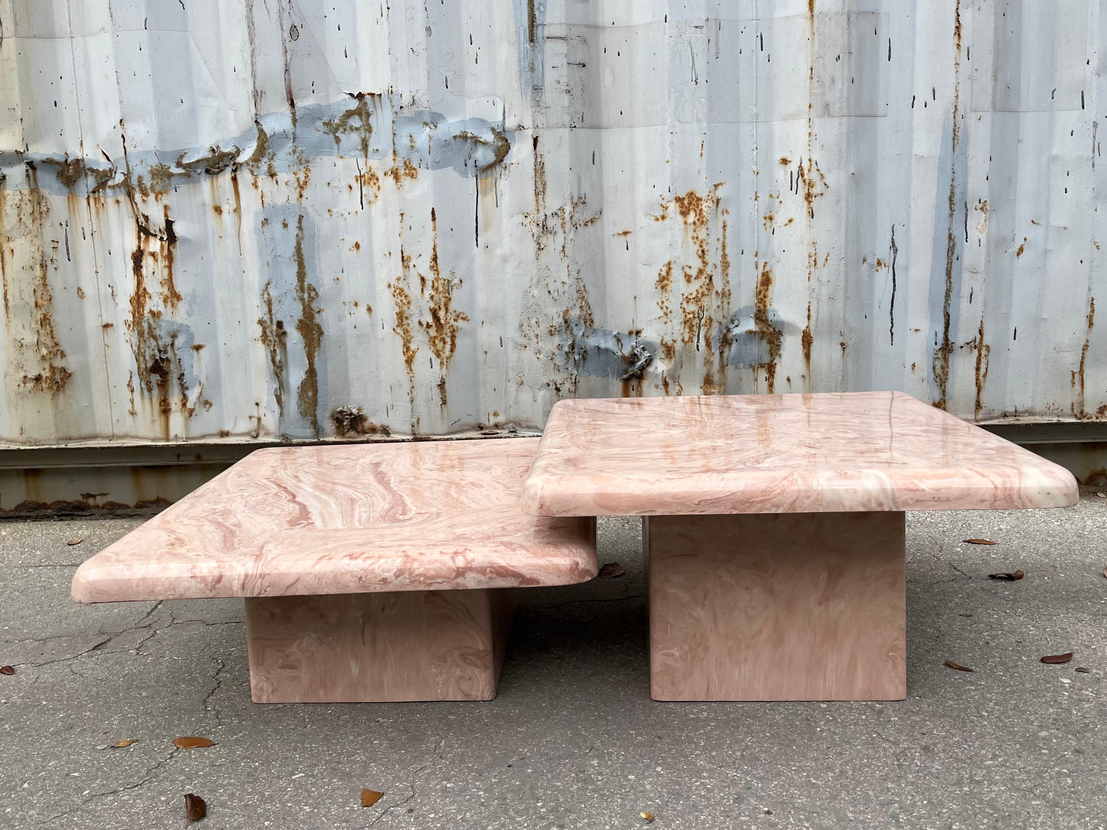 A Pair of Vintage Post Modern Faux Marble Cast Resin Accent / Nesting Tables. Circa 1980s
Feature a minimalist design with rounded edges and beatiful faux stone veins design in shades of pink and cream colors. 
Perfert for indoor or outdoor use.
In