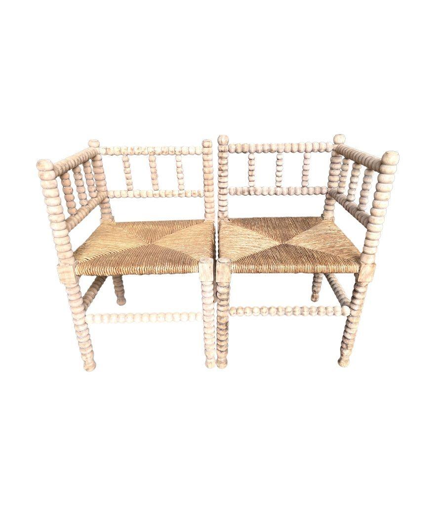 French Provincial A pair of provincial French, bleached oak bobbin corner chairs with rush seats