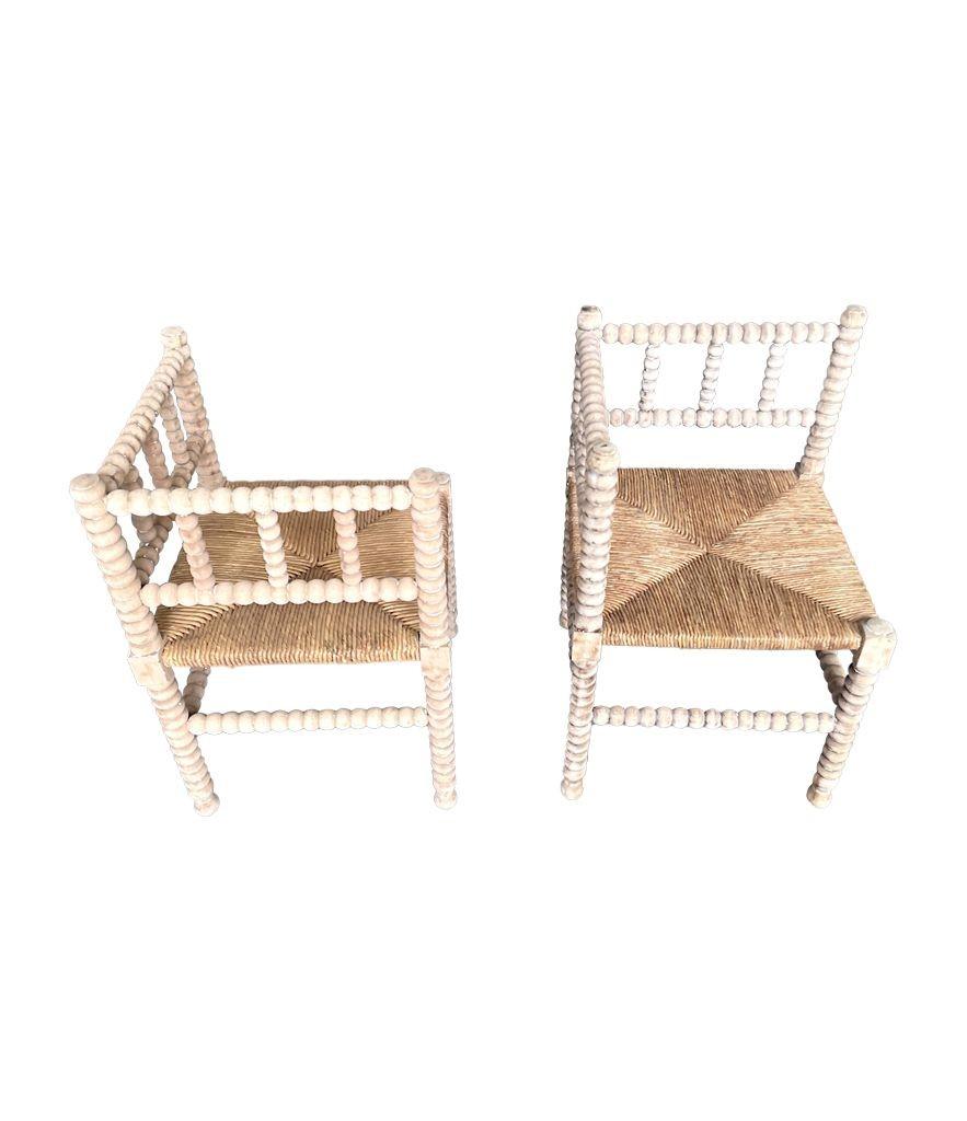 Hand-Carved A pair of provincial French, bleached oak bobbin corner chairs with rush seats
