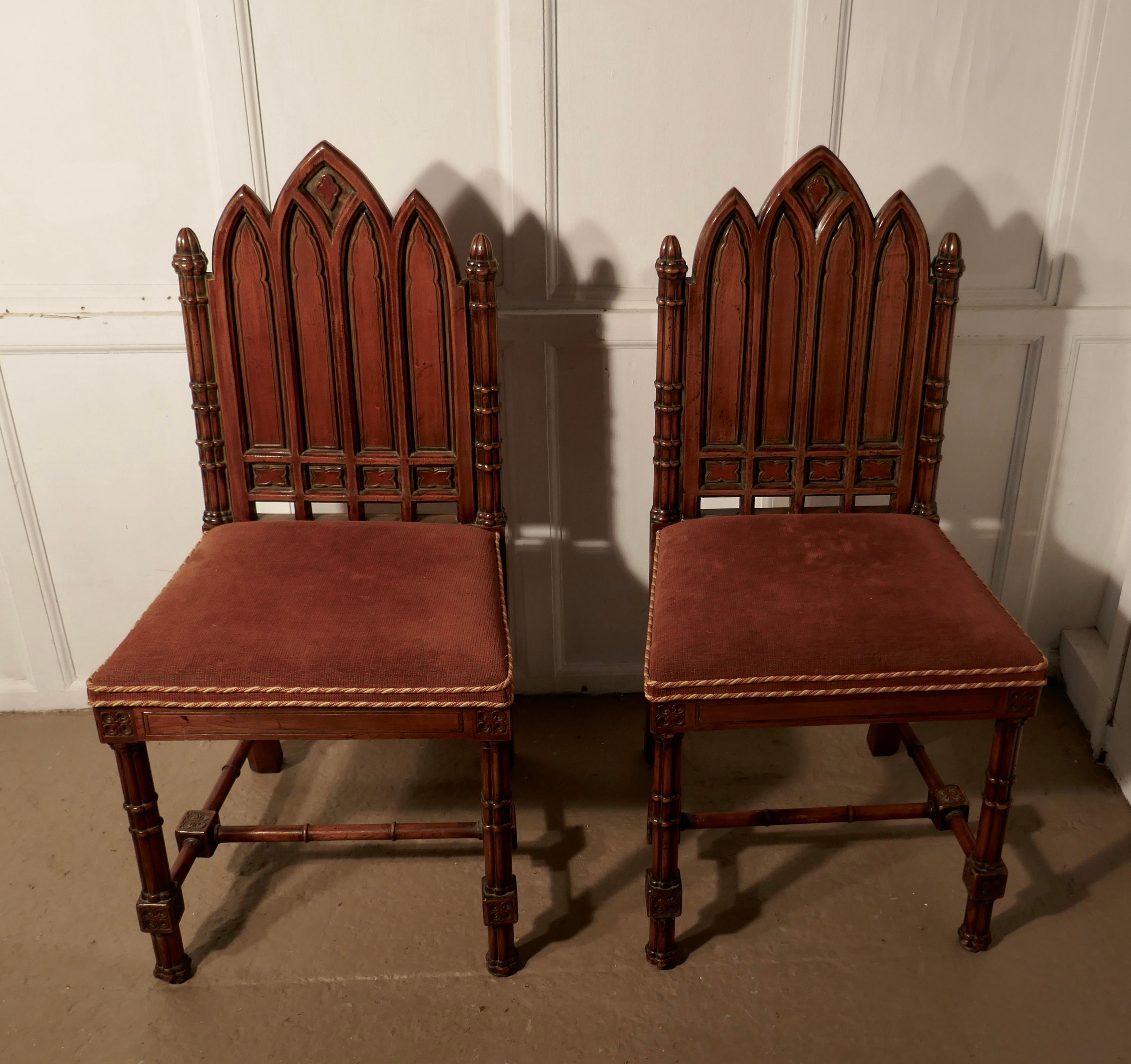 A pair of Pugin style Arts & Crafts carved oak hall chairs

This is a good quality and attractively carved pair of chairs, the chairs are carved in the Pugin style with a row of Gothic columns forming the backrest
The chairs have sturdy turned,