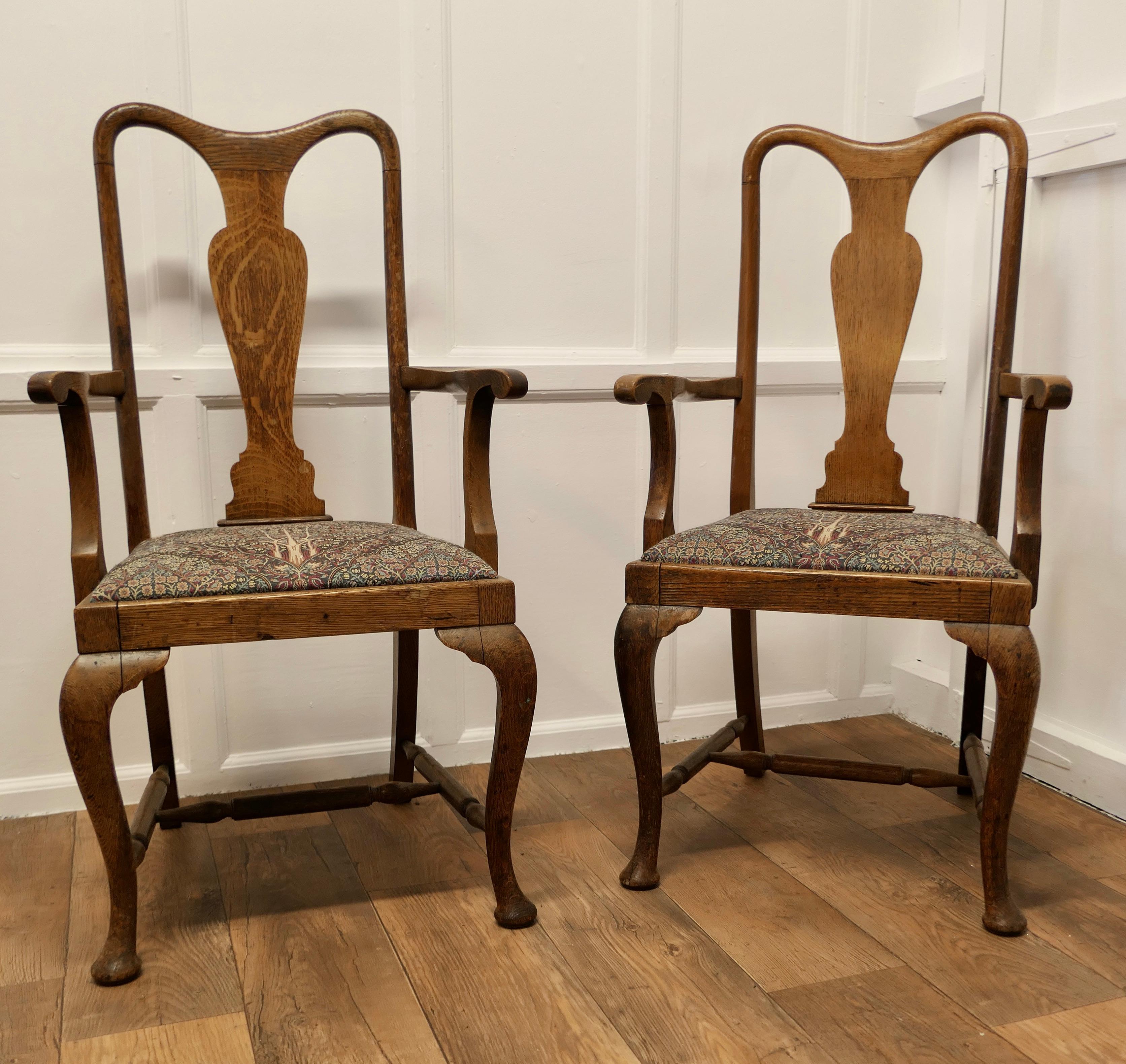 A Pair of Queen Anne Style Oak Carver Chairs 

A lovely looking pair, the seats are upholstered in an Arts and Crafts Islamic style Tree of life Fabric
The chairs are a classic design and made in Oak they have a solid Back Splat with Cabriole