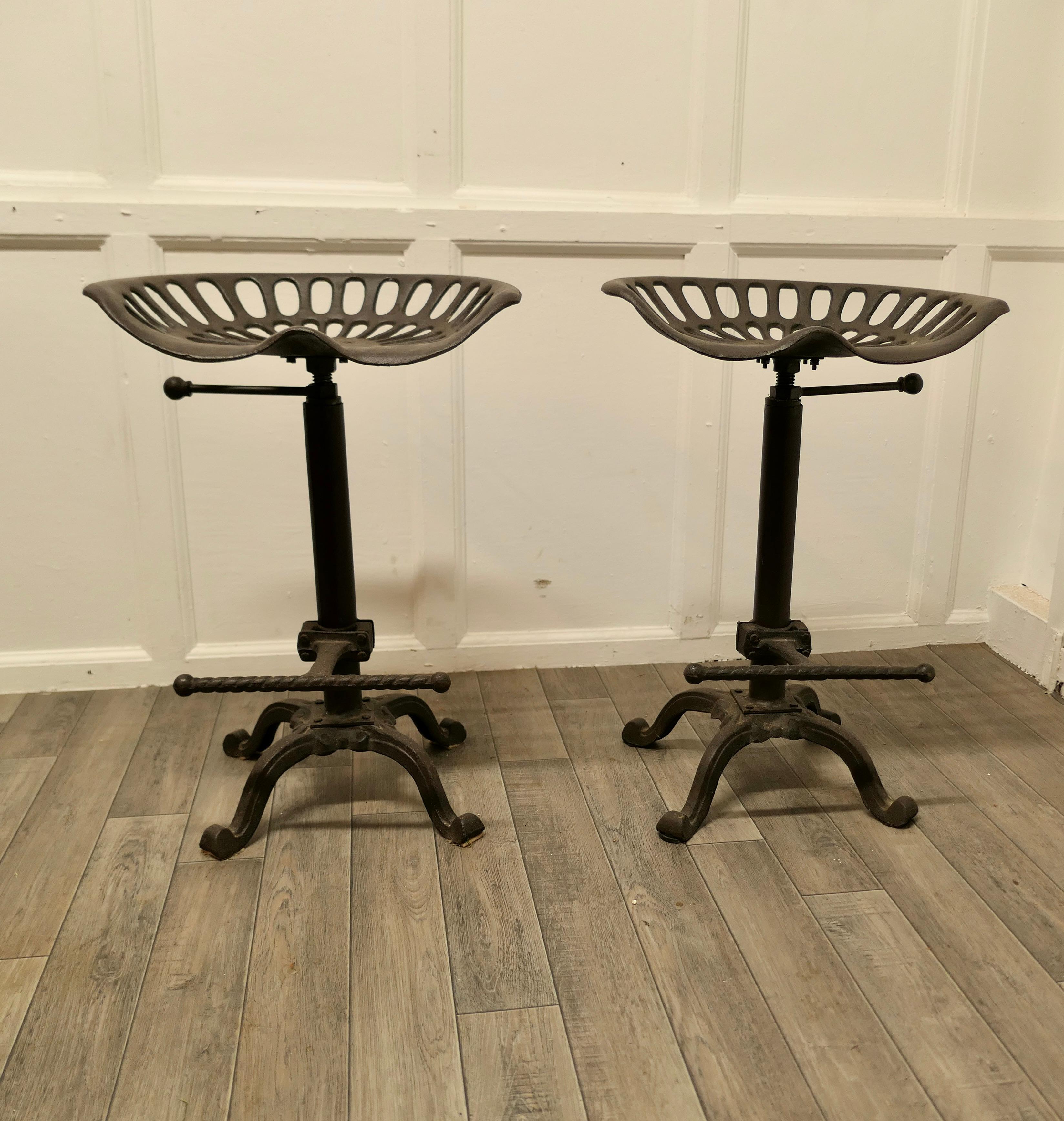 A pair of quirky tractor seat kitchen/bar high stools

Quirky Bar or Kitchen Stools these are a great pair for a Country or Industrial look interior design made in cast iron 
The seats raise and lower from 25” to 28” and the have a twisted foot