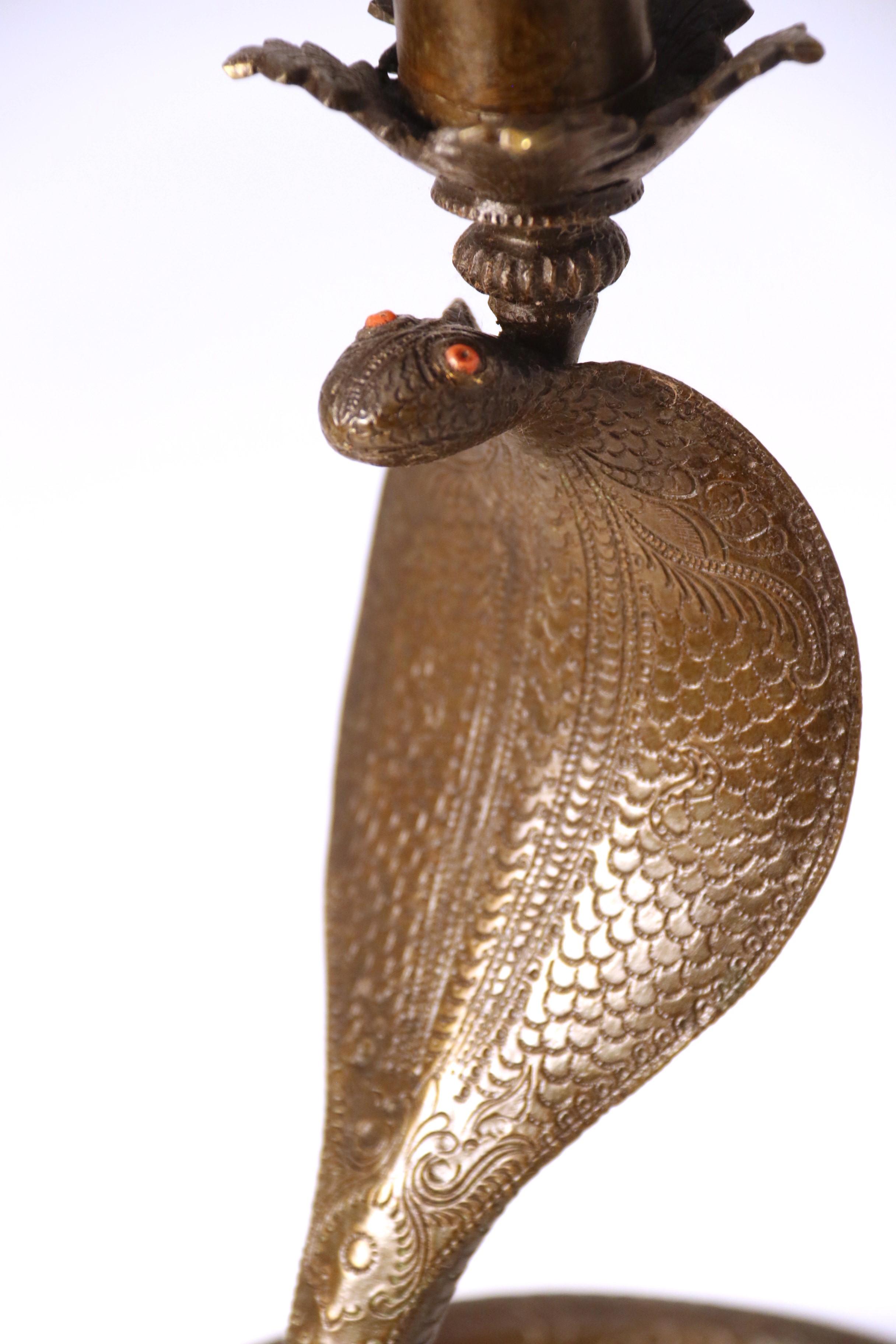A pair of Raj period Indian bronze candlesticks in the form of striking cobras 7