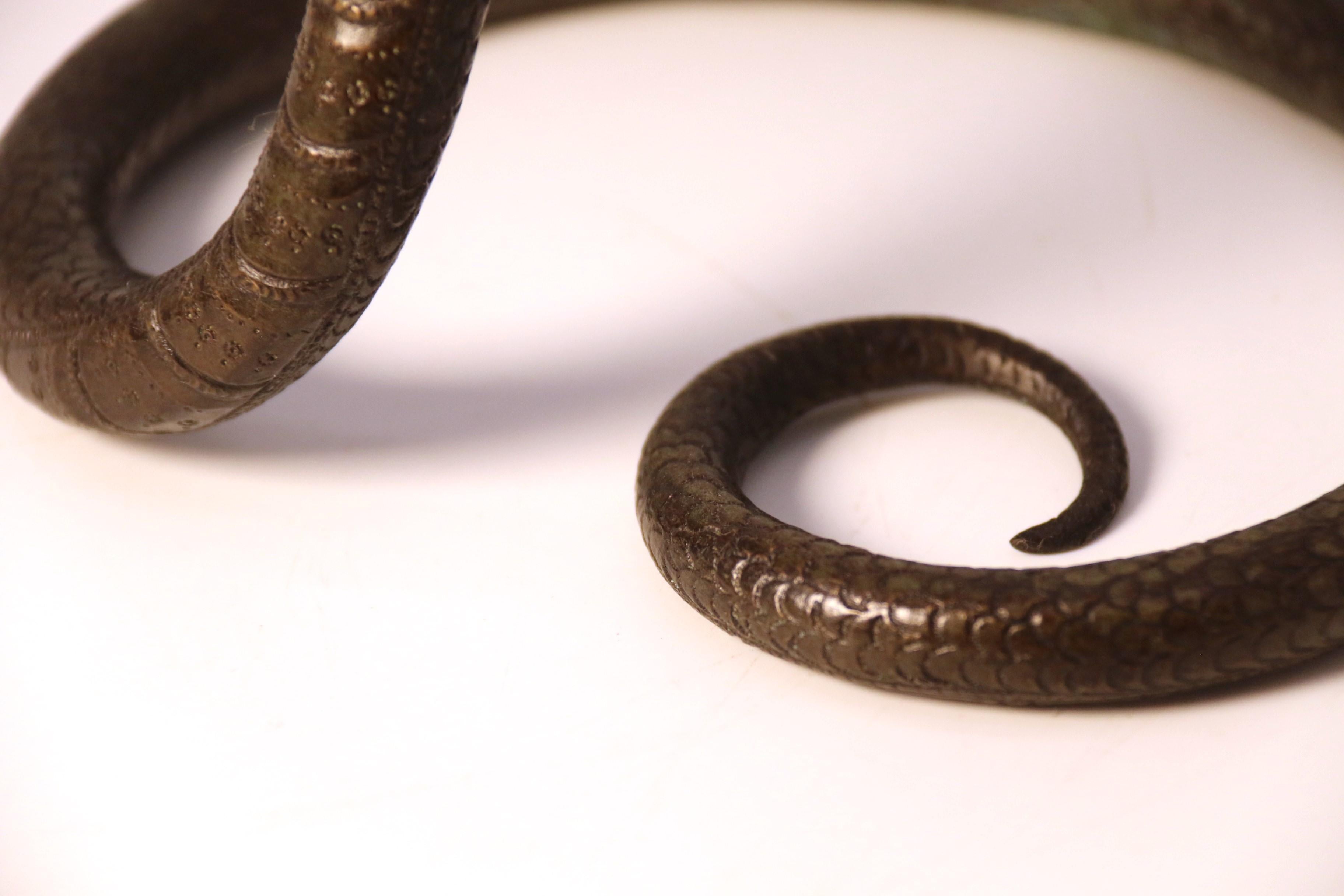 A pair of Raj period Indian bronze candlesticks in the form of striking cobras 8