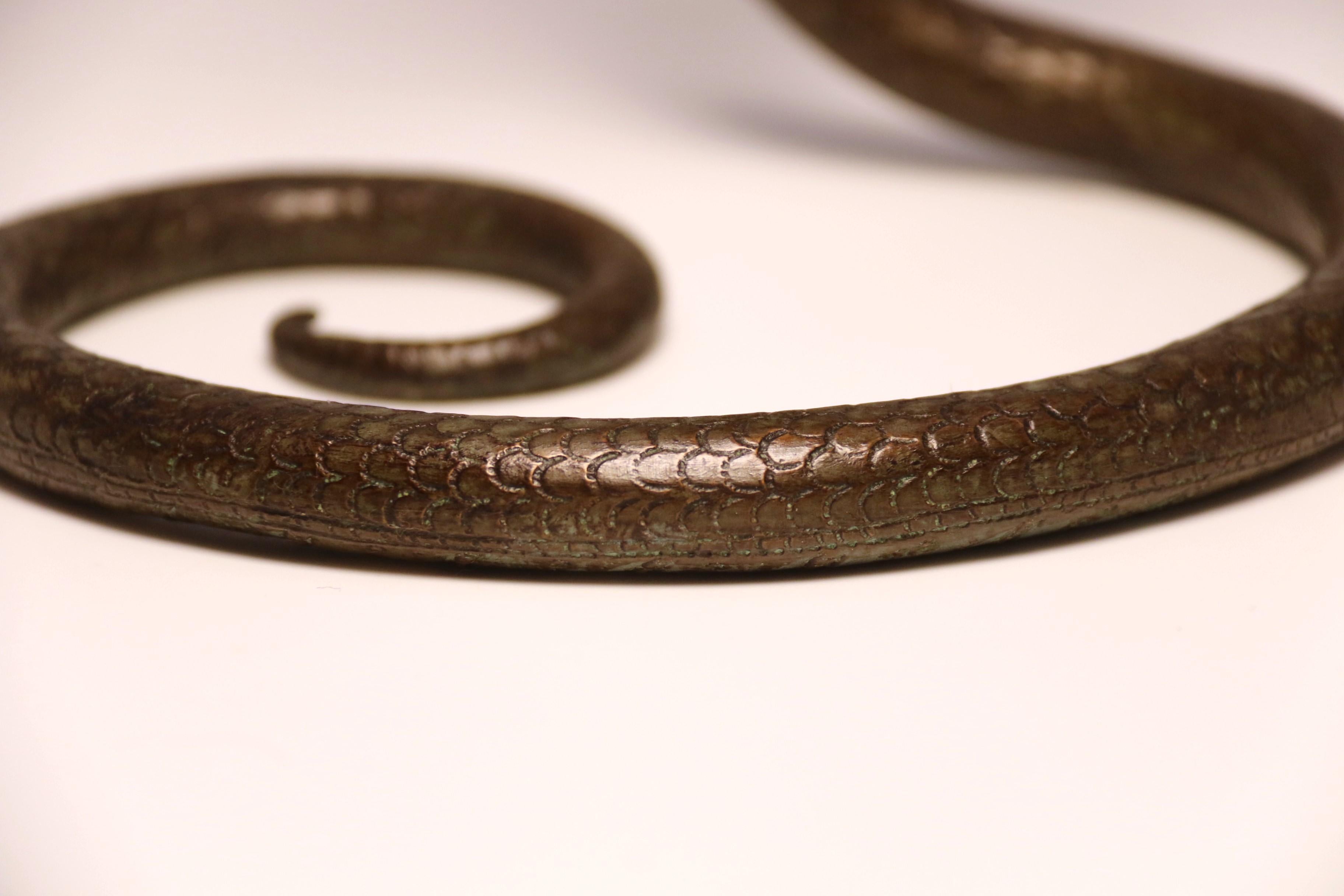 A pair of Raj period Indian bronze candlesticks in the form of striking cobras 12