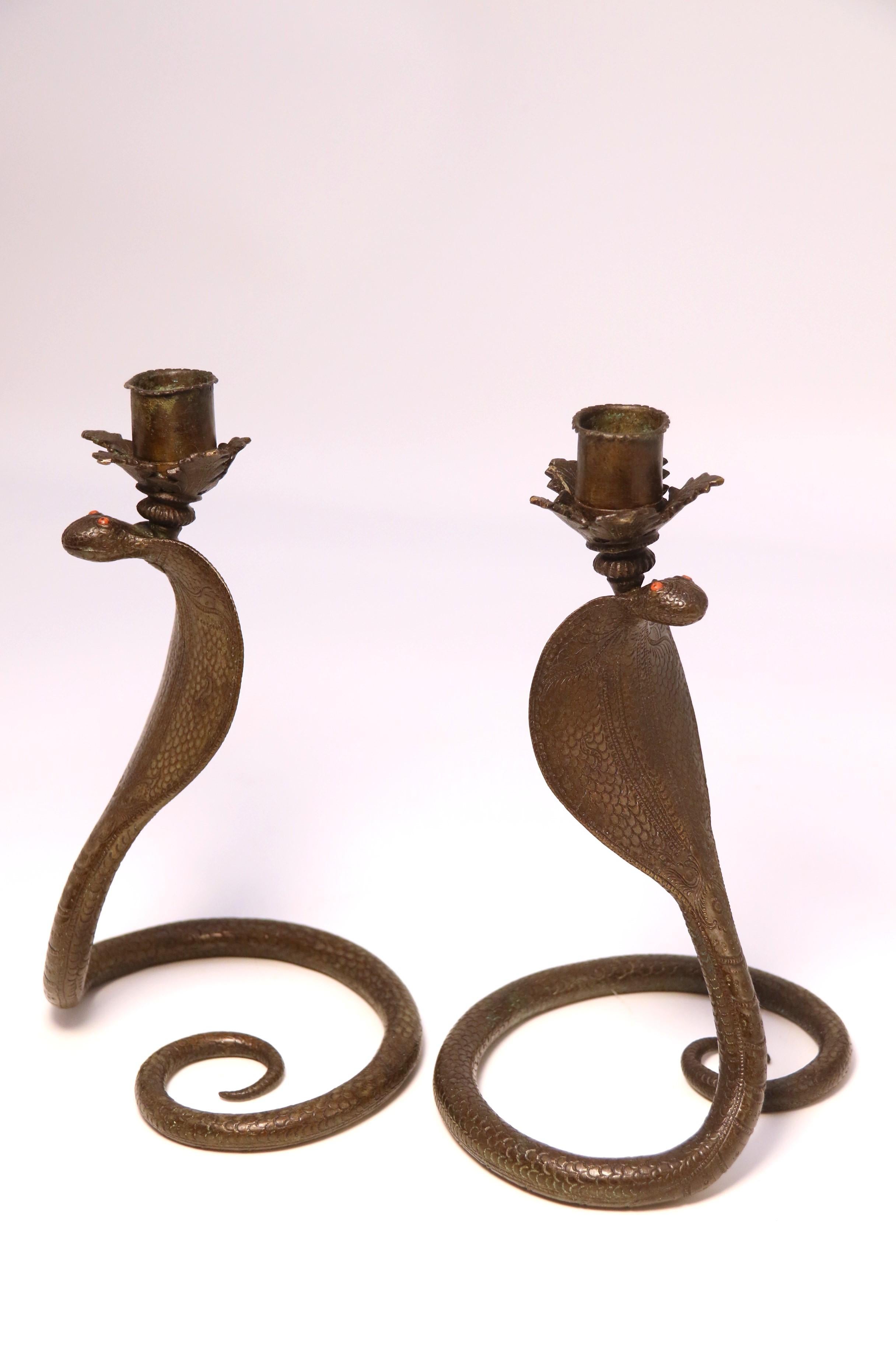 Anglo Raj A pair of Raj period Indian bronze candlesticks in the form of striking cobras
