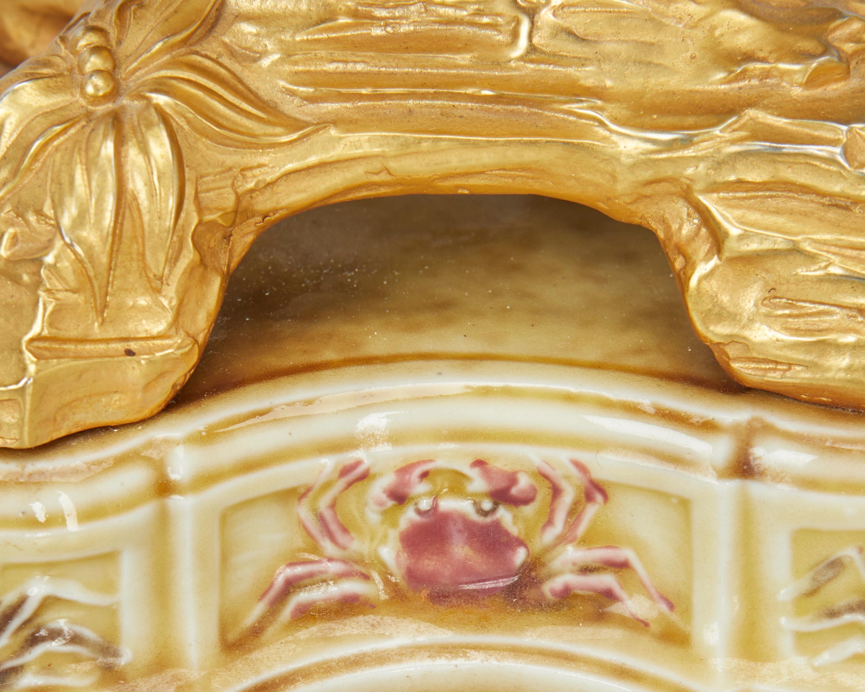 19th century 
 Each with indistinct blue glaze mark to underside; One further numbered: 3307 
 Each candlestick with a cream and mauve glazed porcelain conch shell issuing three naturalistic gilt-bronze foliate arms terminating in a floriform