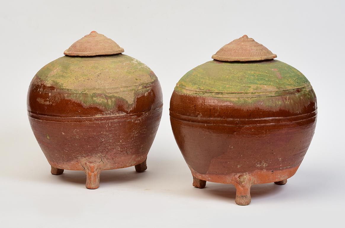 A pair of rare Chinese amber and green glazed pottery globular jar with lids.

Age: China, Han Dynasty, 206 B.C. - A.D. 220
Size: Height 24.6 - 24.8 C.M. / Width 21.5 - 21.8 C.M.
Condition: Well-preserved old burial condition overall with some