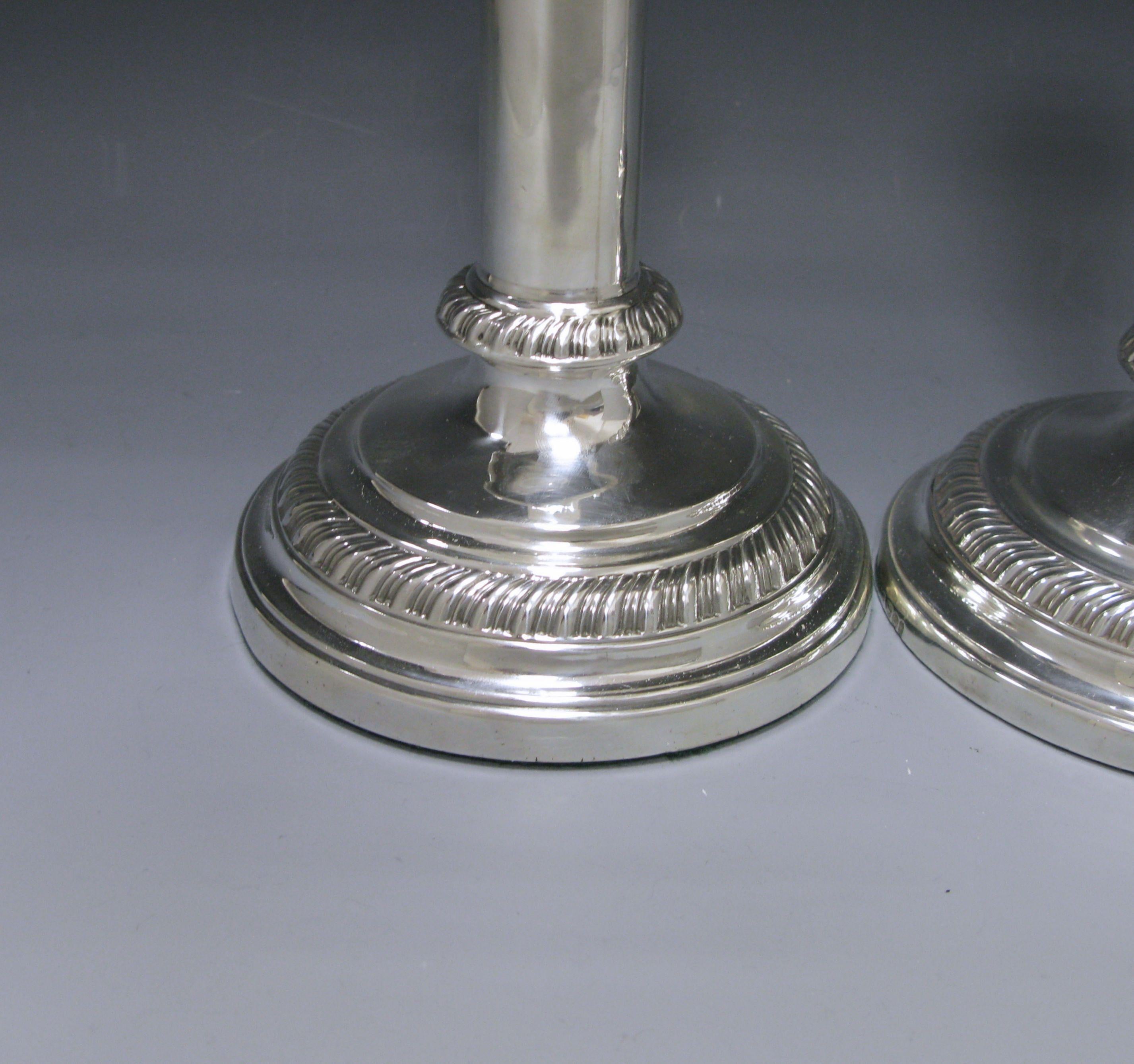 A pair of rare antique silver telescopic candlesticks with round gadroon border bases, the border is also repeated on the detachable nozzle.

Measures: Height when not extended 8.25 inches 21 cm.
Height when extended 10.75 inches 27.4 cm.