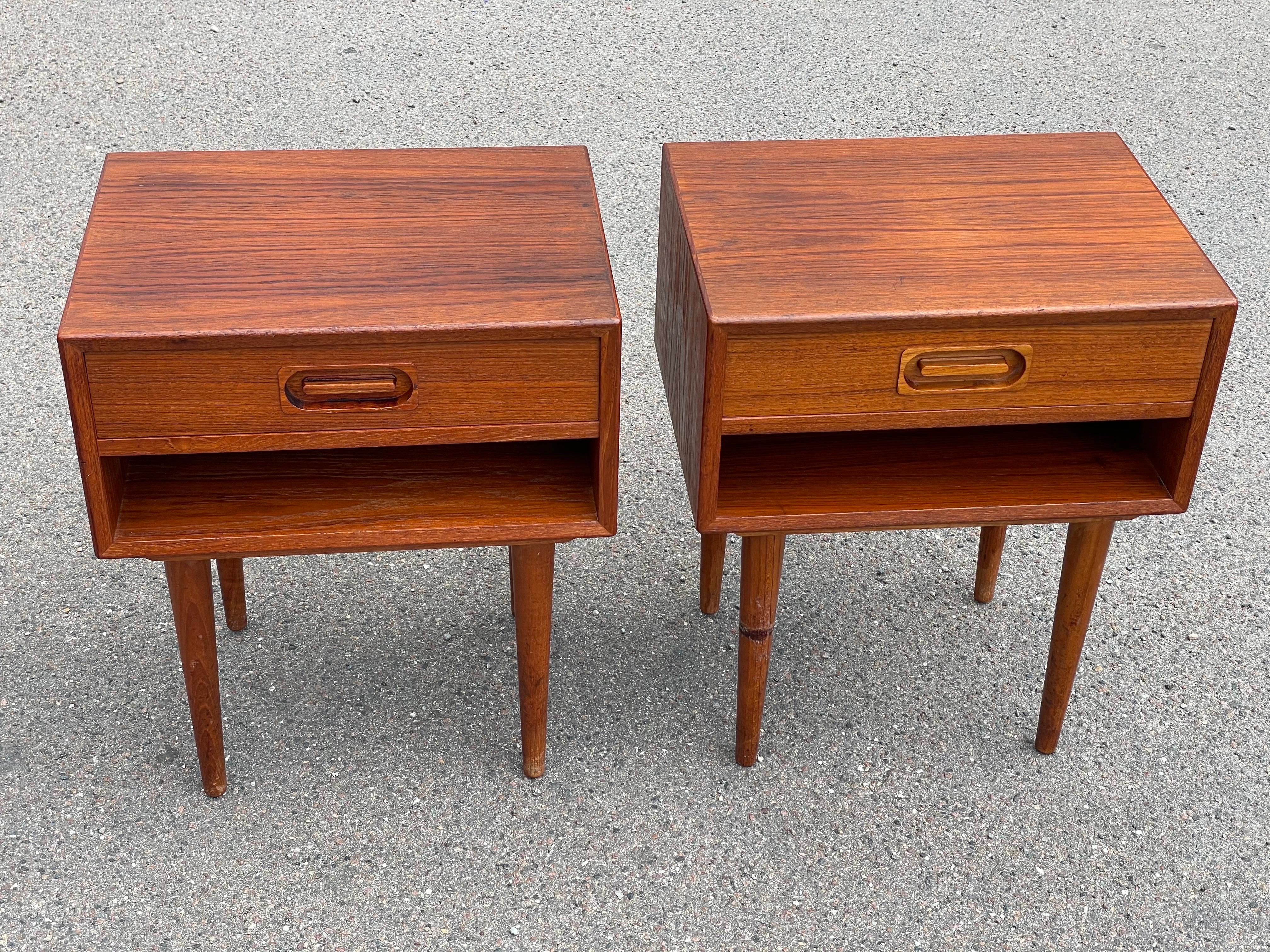 A remarkable pair of rare Johannes Andersen teak nightstands from the 1960s, crafted with precision for the esteemed Dyrlund furniture makers. These mid-century modern masterpieces embody the timeless elegance and functionality synonymous with