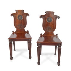 A pair of rare Regency mahogany hall chairs from the Bateson family