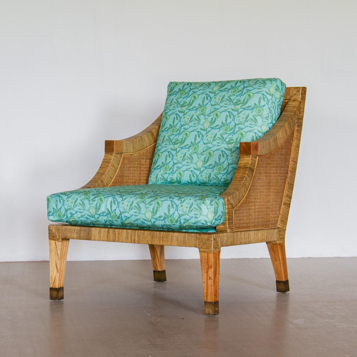 A pair of rattan framed armchairs upholstered by KBS in a turquoise and green foliage linen, 1970s.