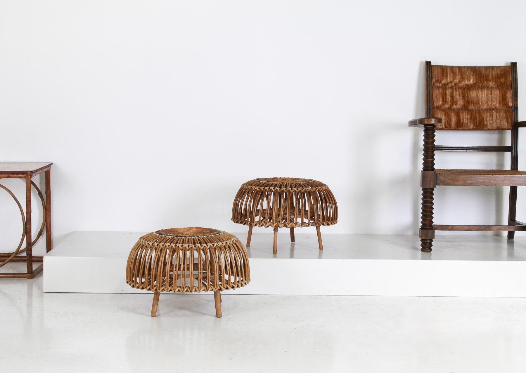 Crafted in the iconic ‘Lobster Pot’ style popularised by renowned Italian designer Franco Albini in the 1950s, this handsome pair of mid-century (circa 1970s) wicker ottoman footstools offer a chic and versatile addition to any mid-century modern or