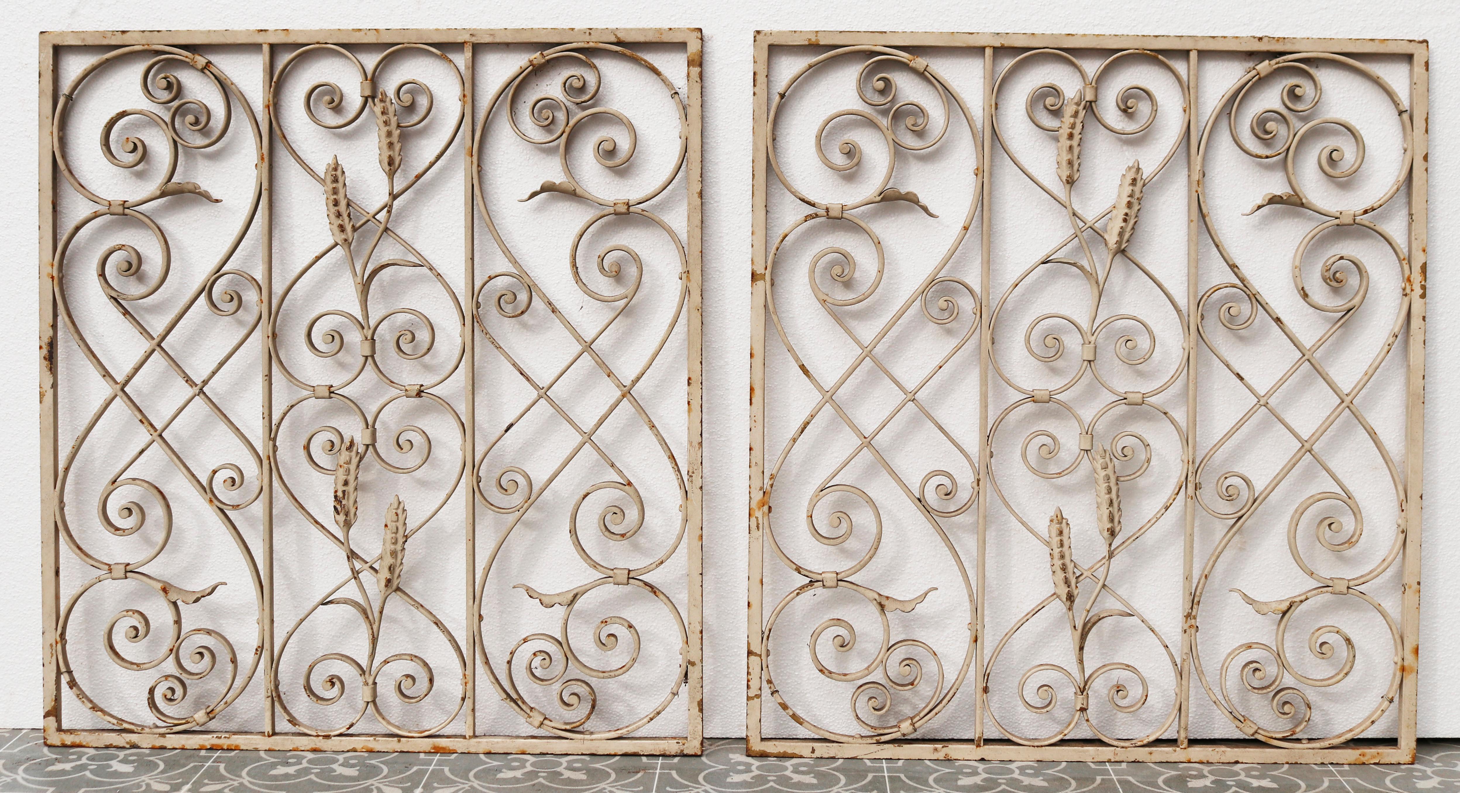 Two reclaimed wrought iron panels featuring scrolls and wheat sheaf's. Painted wrought iron, salvaged from from the Crescent in Bath. We have two further lots available.

Additional Dimensions:

Each 65 x 60 cm