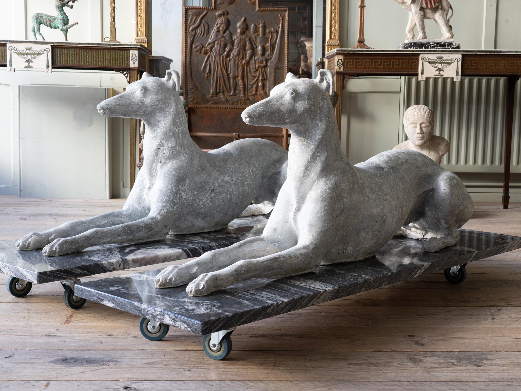 A pair of large handed composition stone recumbent Greyhound attributed to Austin & Seeley.

This model appear in the company’s 1841 catalogue.

Set on new composition marble bases.

English, circa 1840.

Price is for the pair.

Measures: