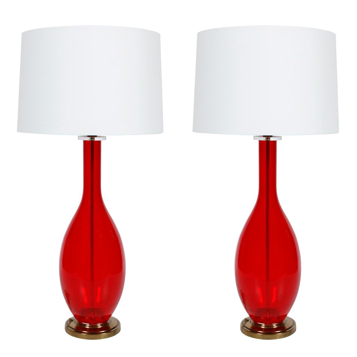 A pair of red glass, tear drop shaped vintage lamps with brass base.