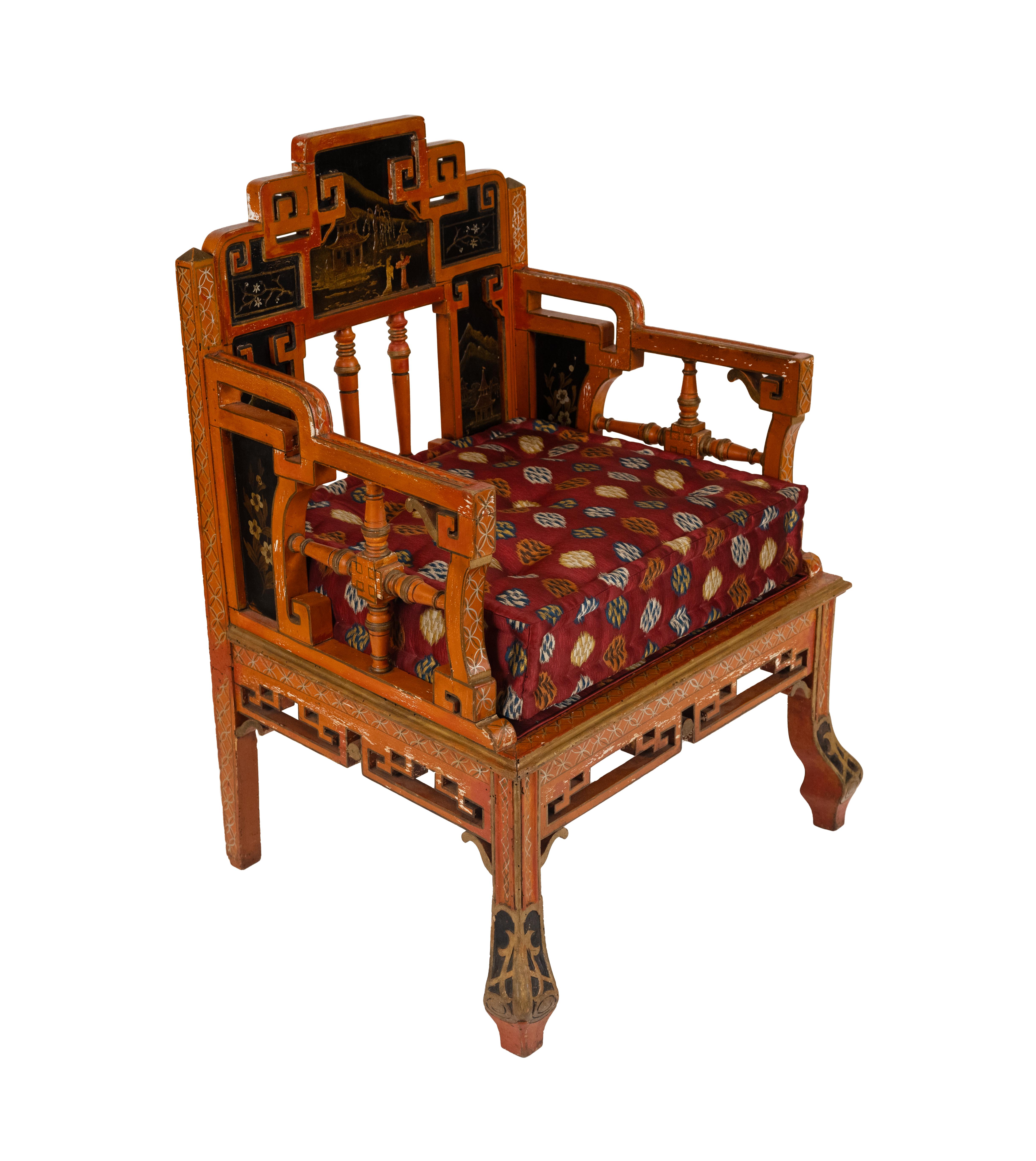 This enchanting pair of early 20th-century red-painted chinoiserie armchairs showcases exceptional craftsmanship and artistic detailing. Hand-painted scenic panels depict idyllic landscapes, pagodas, and floral motifs, all rendered in a rich black