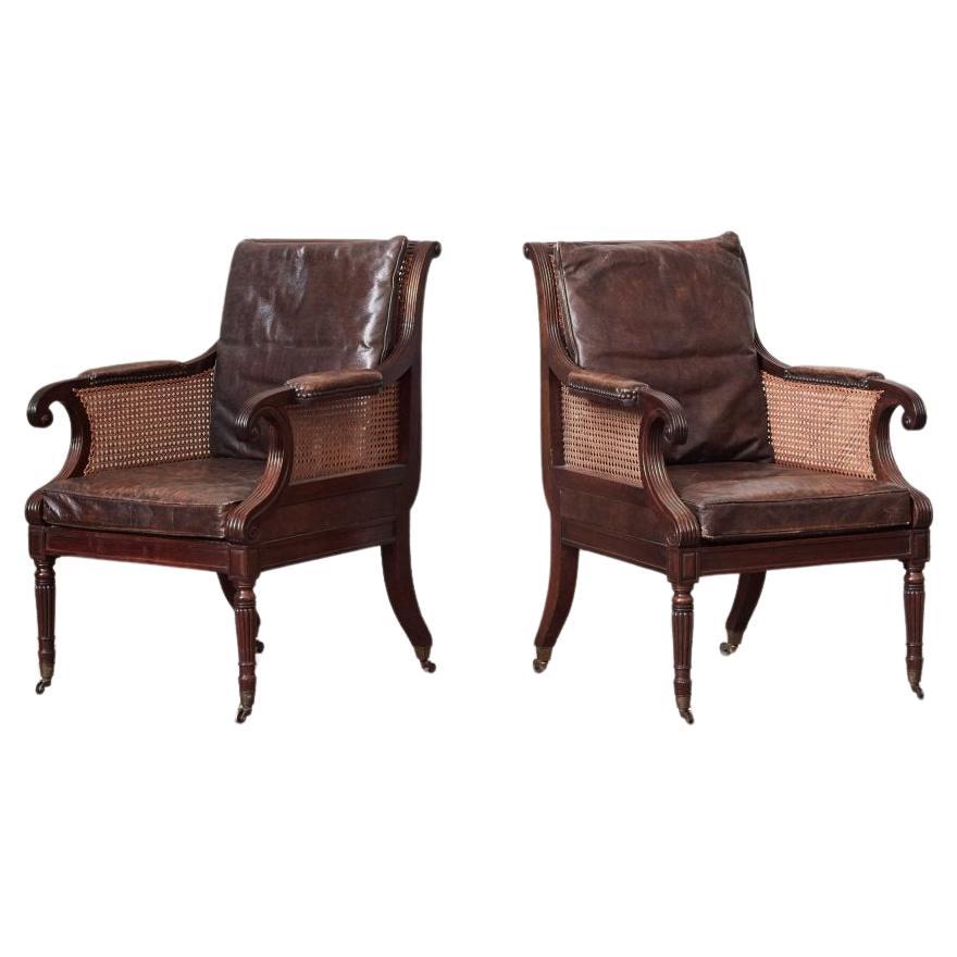 A Pair of Regency Caned Bergeres, with Leather Squab Cushions