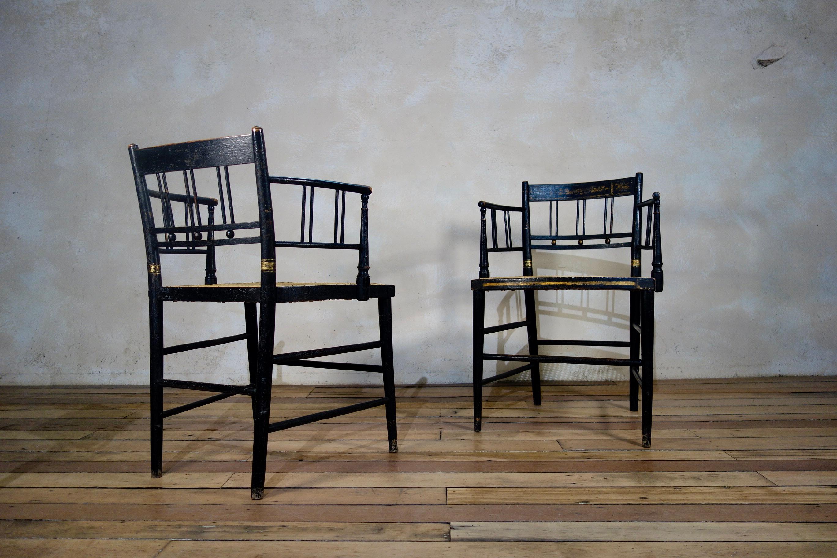 British A Pair of Regency 19th Century Ebonized Gilded Open Armchairs - Chair, Caned