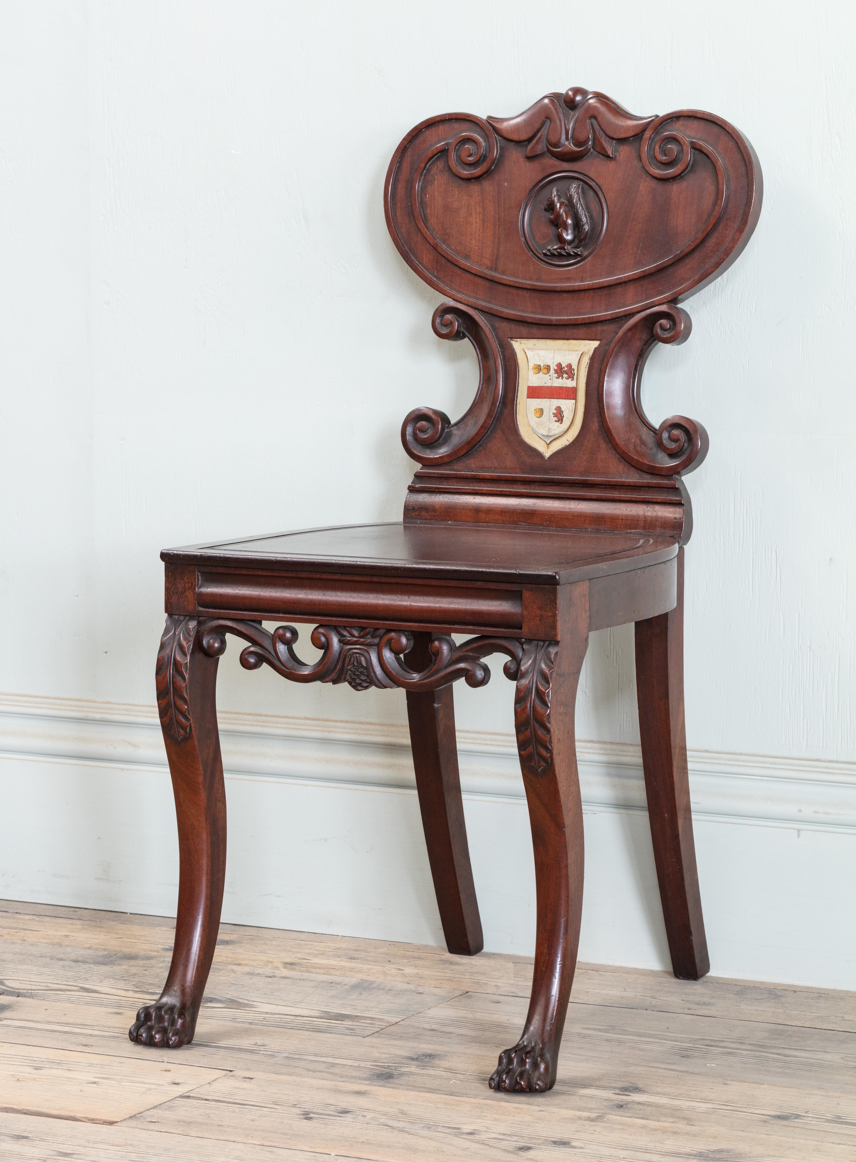 British Pair of Regency Mahogany Armorial Hall Chairs, with Unusual Carved Squirrels For Sale