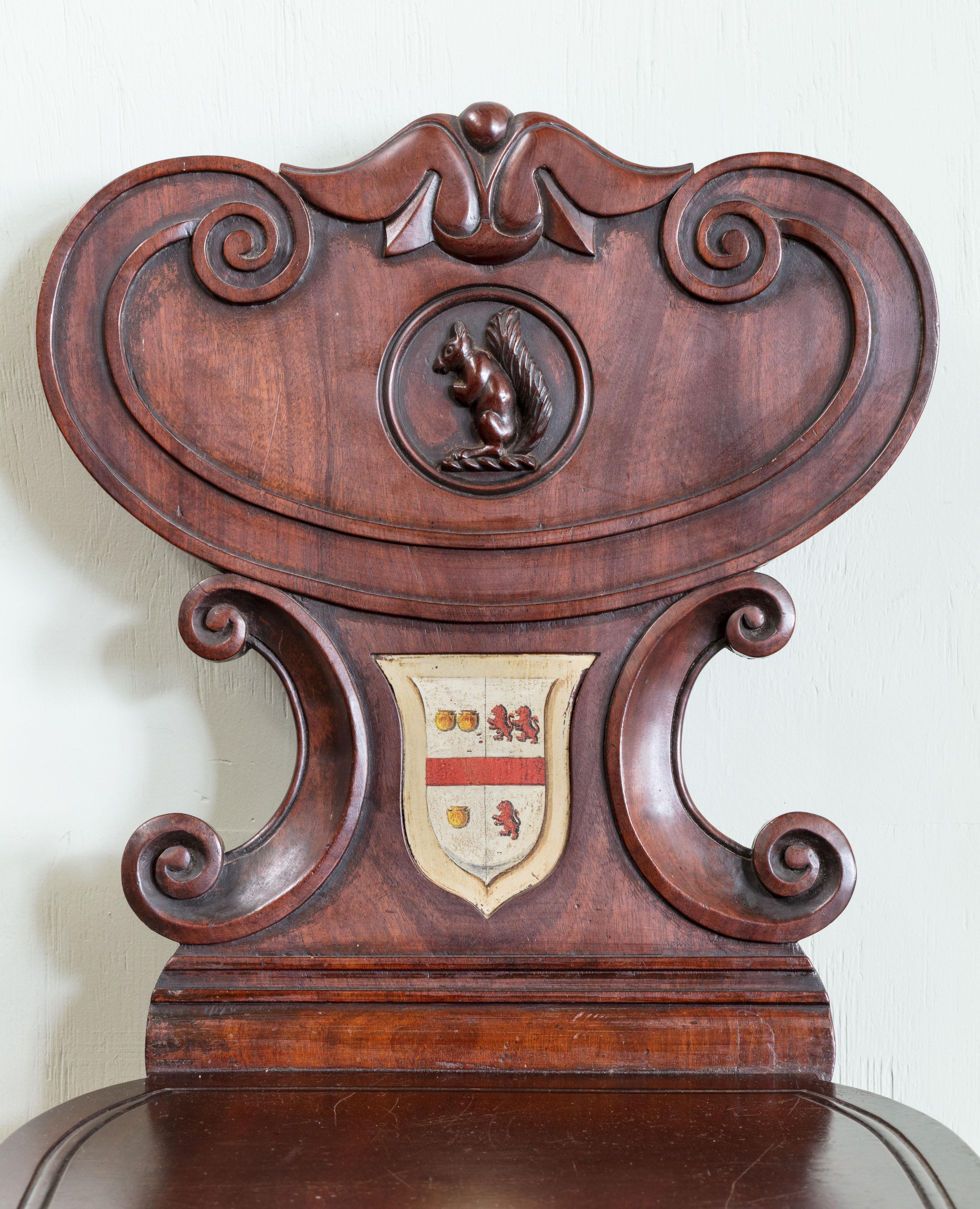 British Pair of Regency Mahogany Armorial Hall Chairs, with Unusual Carved Squirrels For Sale