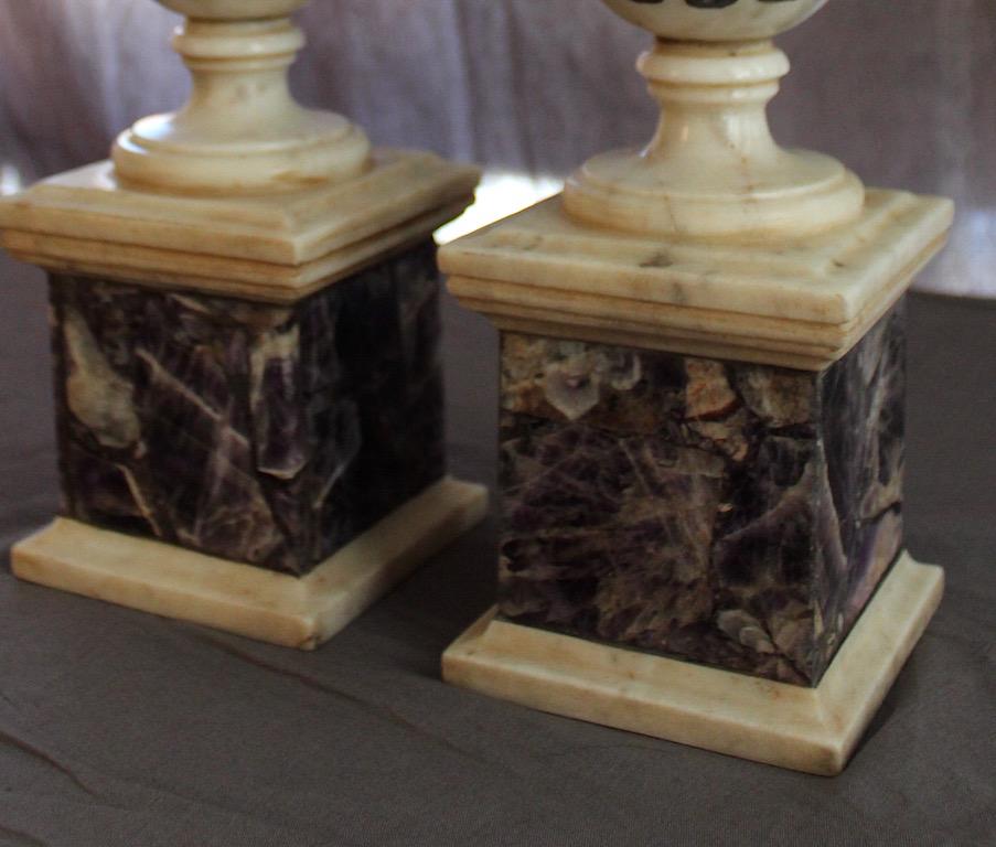 A pair of Regency marble and blue John classical urns, circa 1820
A carved white marble and Blue John inlaid urn on stand, after the antique, 19th century, with a knopped lid above an inlaid fluted bowl on a waisted stem above a blue john and white