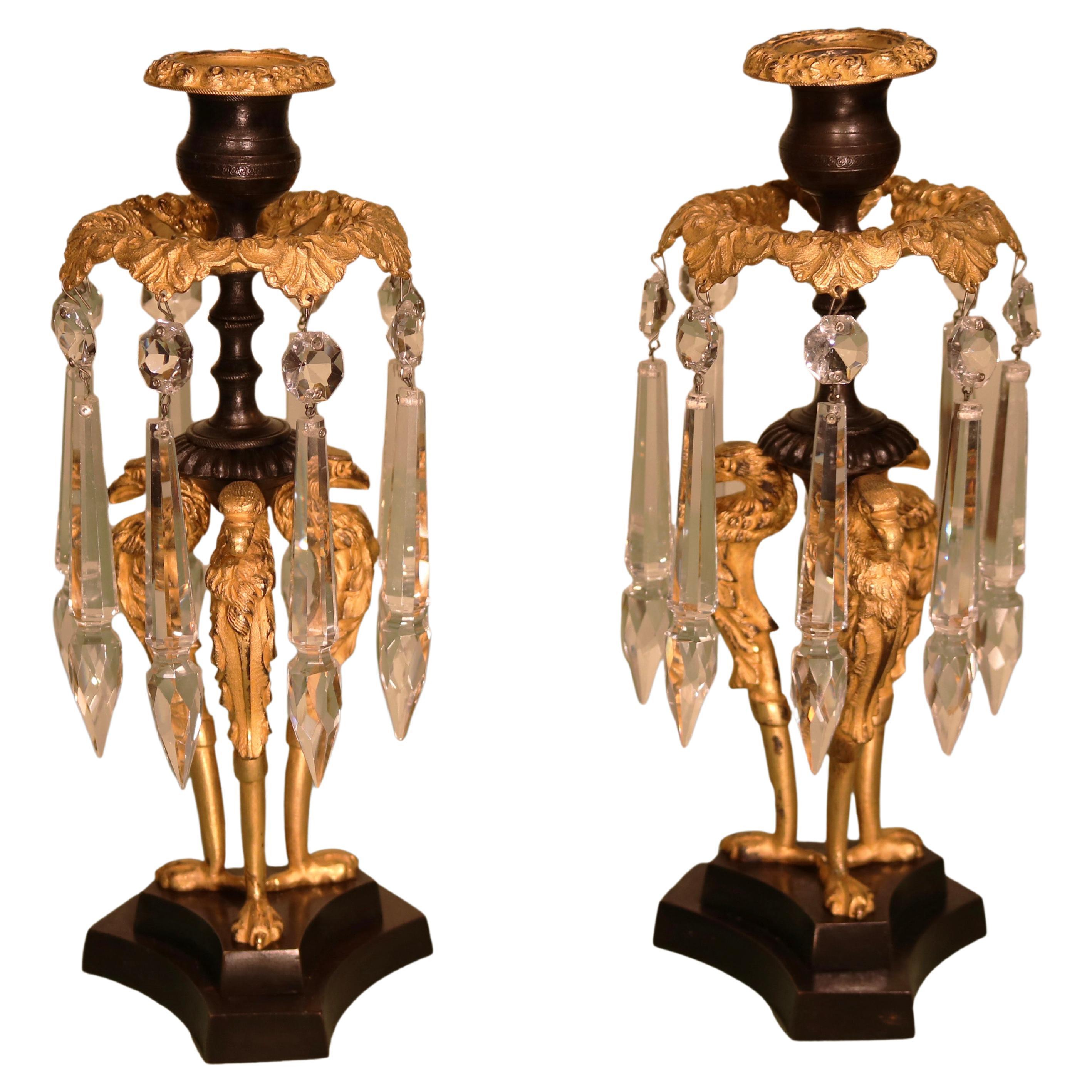 A pair of Regency period bronze and ormolu Griffin lustres For Sale