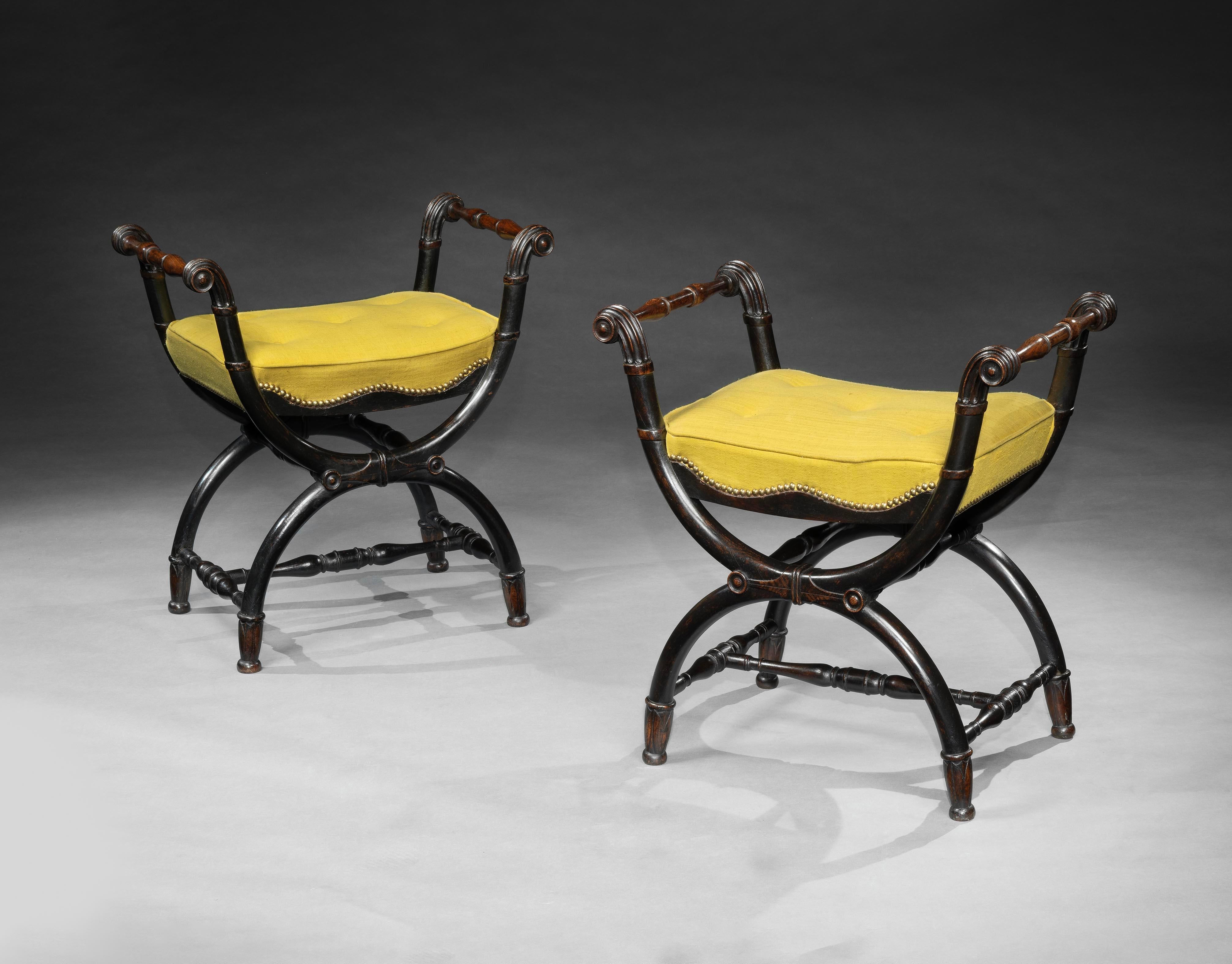 Each with rectangular padded seats upholstered in an antique yellow linen fabric. On moulded X-framed legs, joined by baluster stretchers ending on leaf wrapped feet.

These Seats are highly unusual for being produced in oak, and furthermore the