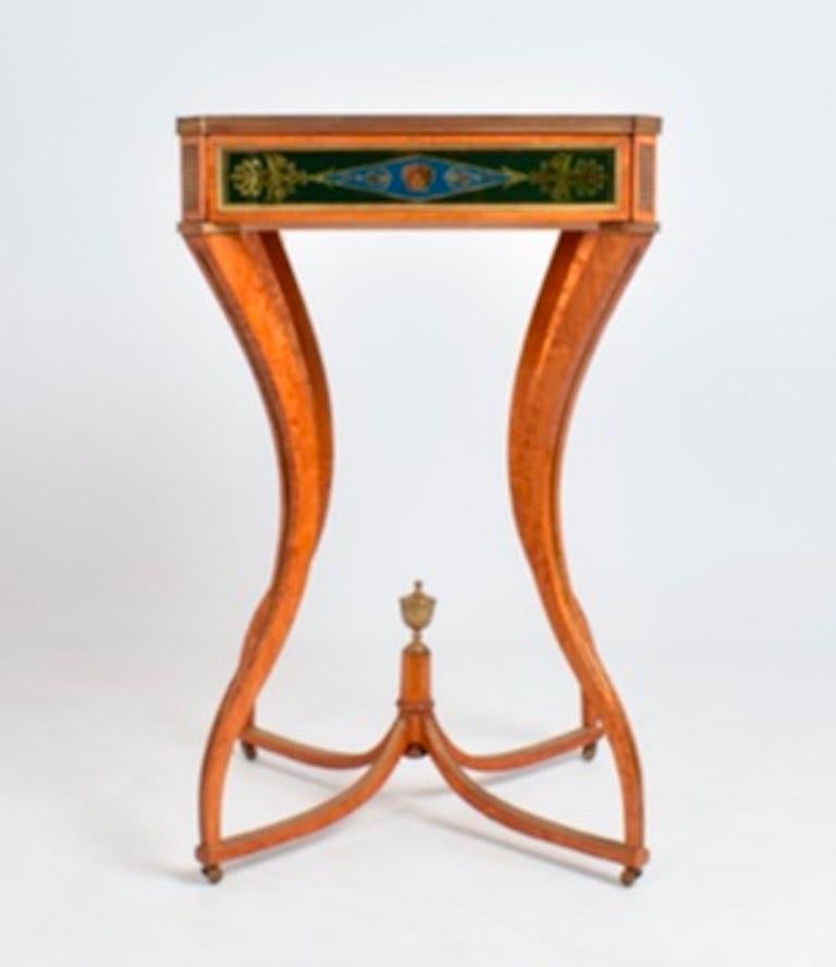 A magnificent pair of high regency satinwood side tables with a single drawer. The legs are shaped with a stunning curve making them very unique. The drawer is surrounded by painted glass and brass inlay. We have never seen a table like it, and the