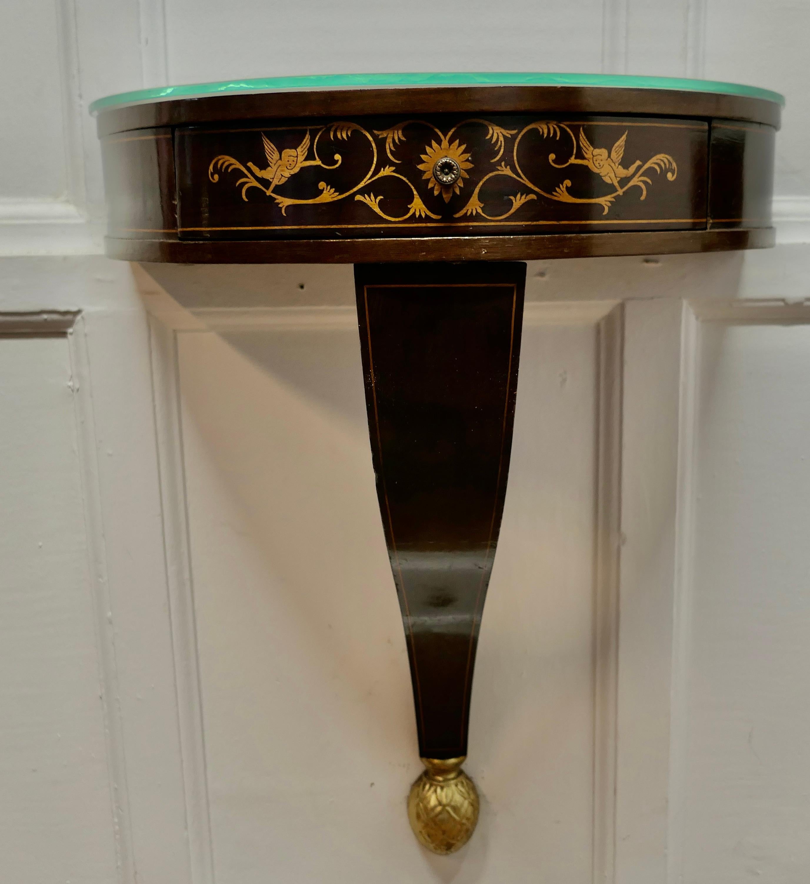 A Pair of Regency Style Console Wall Table Brackets

Two beautifully designed little console tables, the decoration is in the regency style with angels and acanthus leaves
The shelves have a Demi Lune shape, a drawer to the front and a shaped leg