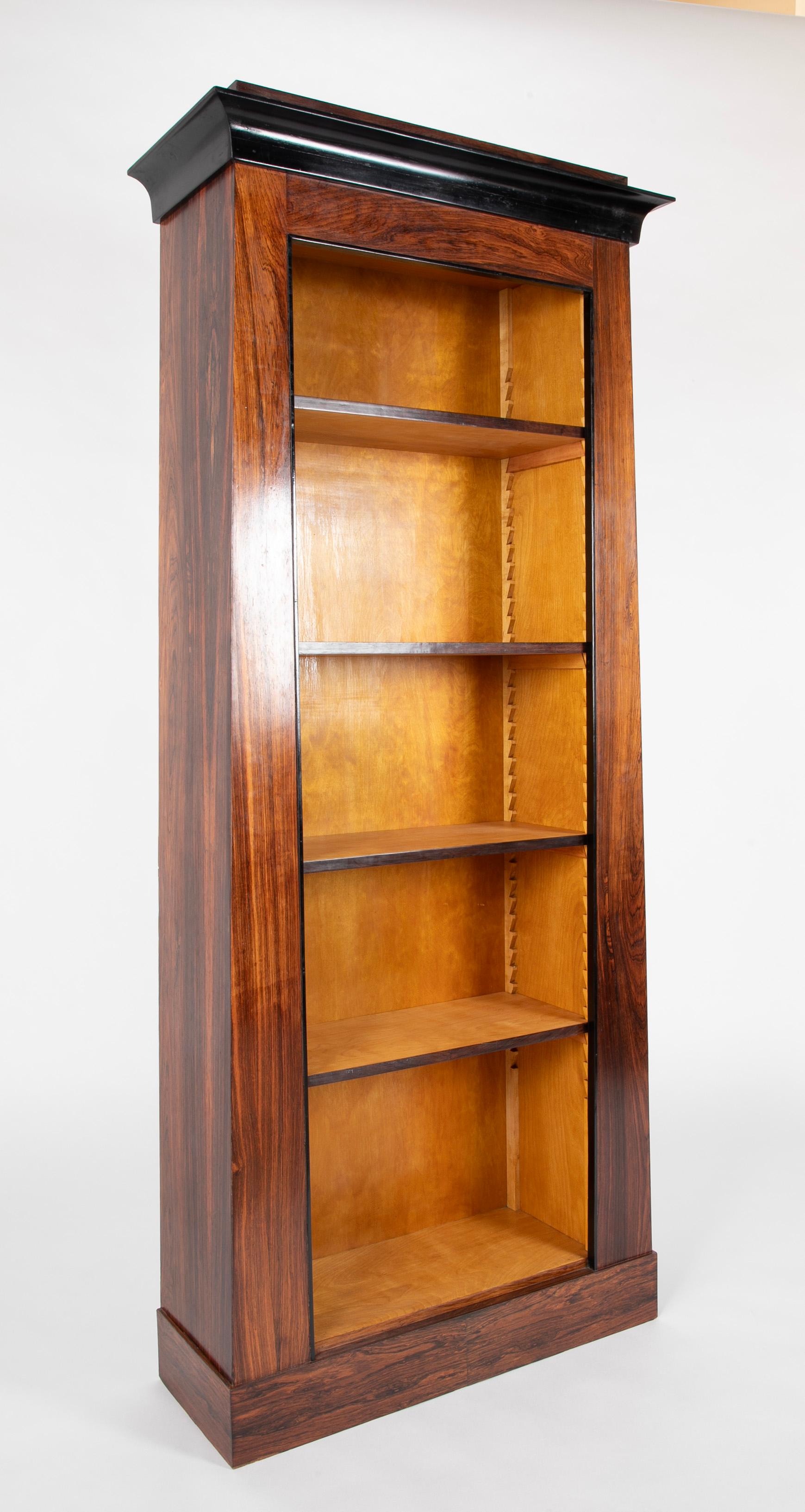 Stunning pair of custom made Regency style rosewood veneered bookshelves with ebonized trim. With five adjustable shelves each. 
These handsome shelves are beautifully made by a master craftsman. 
76.5 inches high by 32 wide by 11.75 deep.