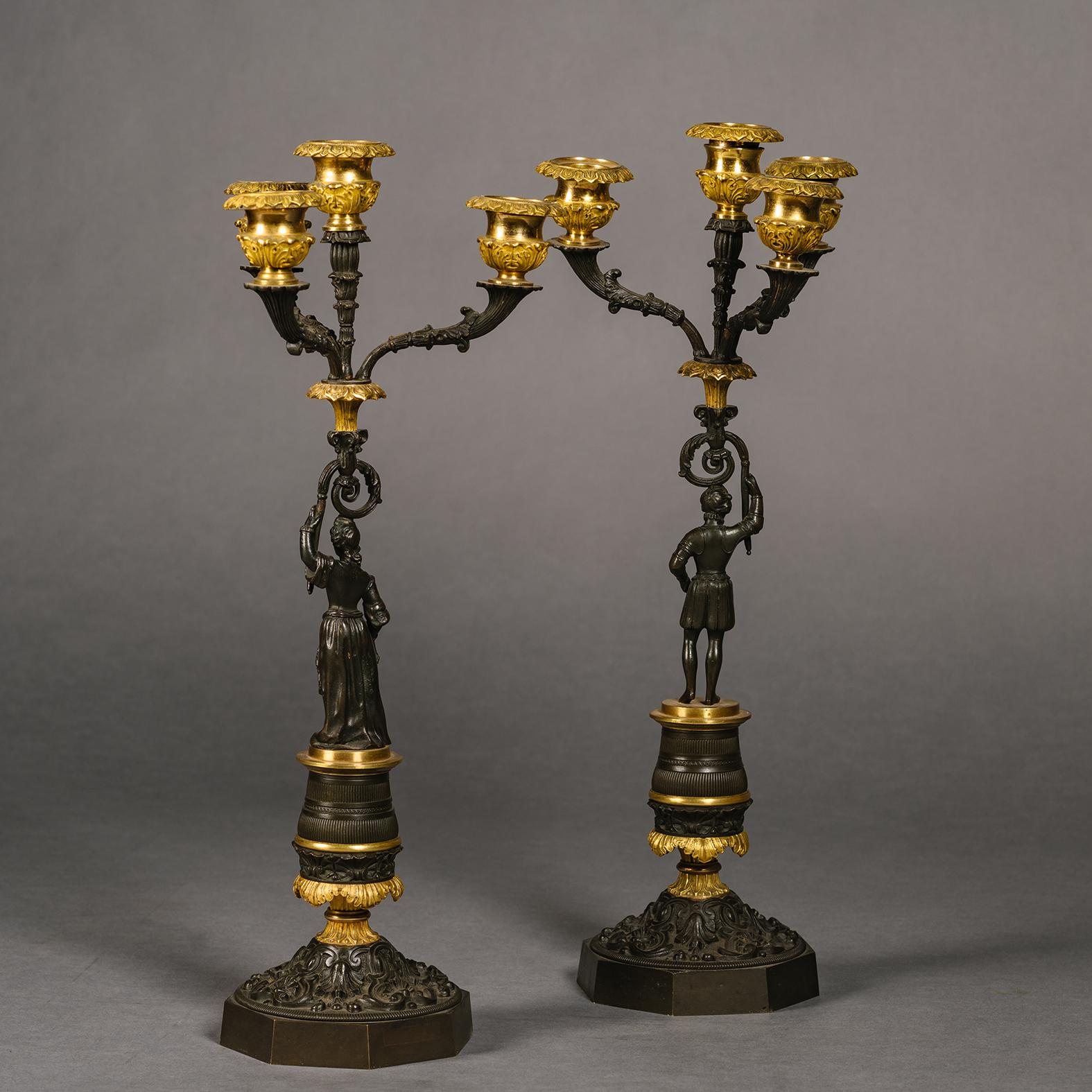 A Pair of Restoration Period Gilt and Patinated Bronze Four-Light Figural Candelabra.

French Circa 1830.