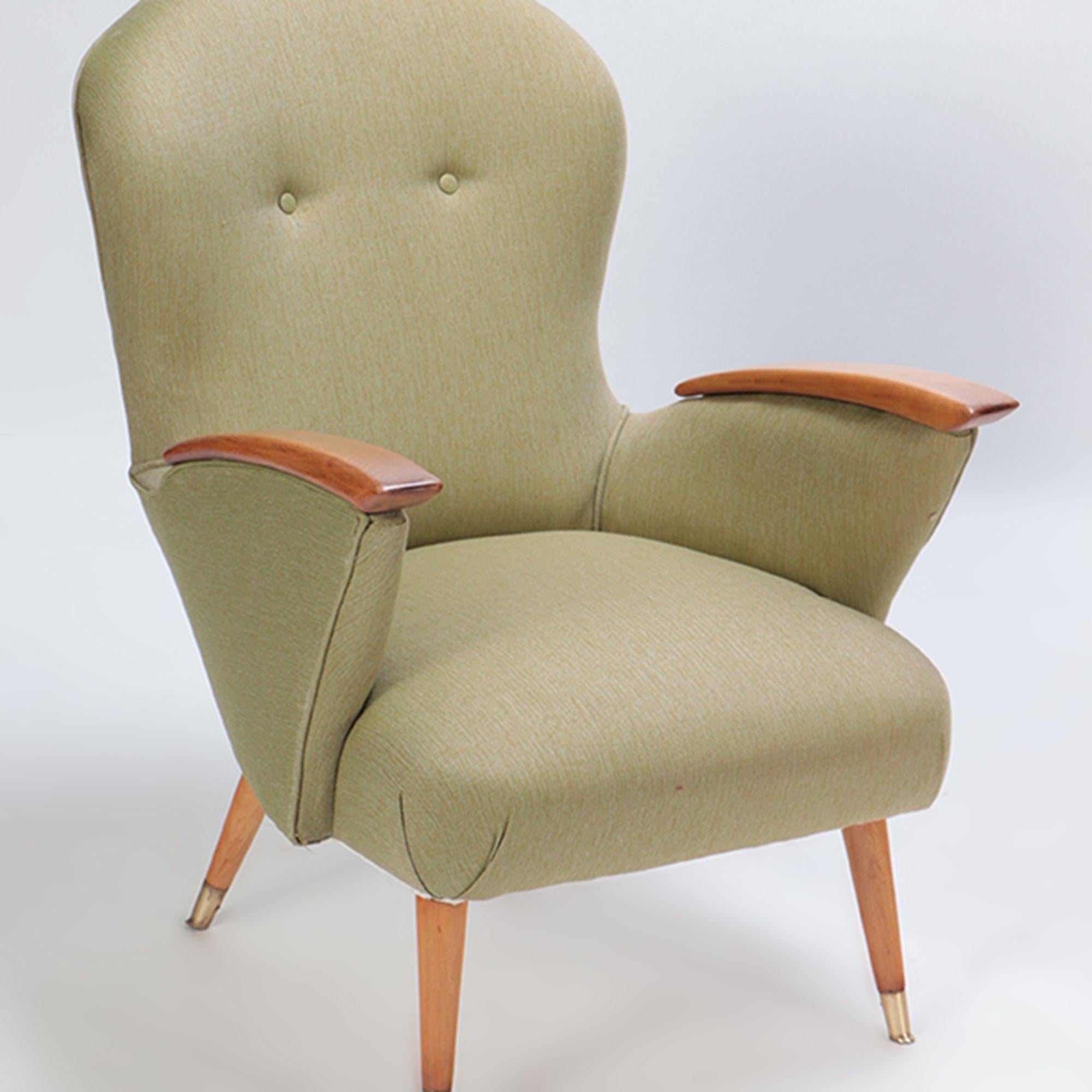 A Pair of restored Danish armchairs with rolled arms and supported by four angled legs ending in brass casters. Newly upholstered. circa 1950.