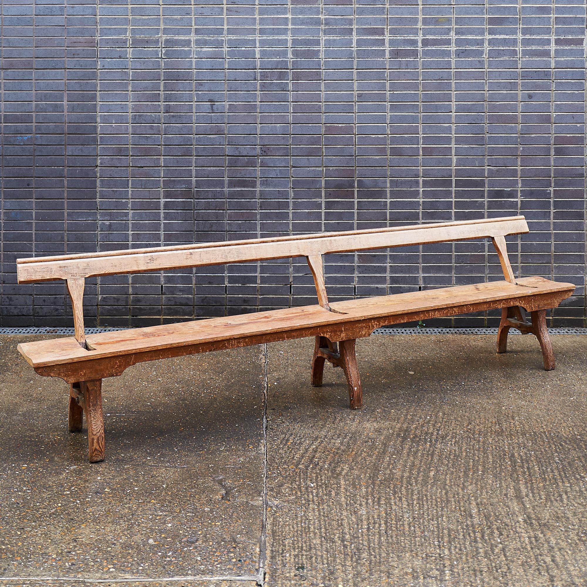 A pair of very long reversible railway station benches made from pitch pine.