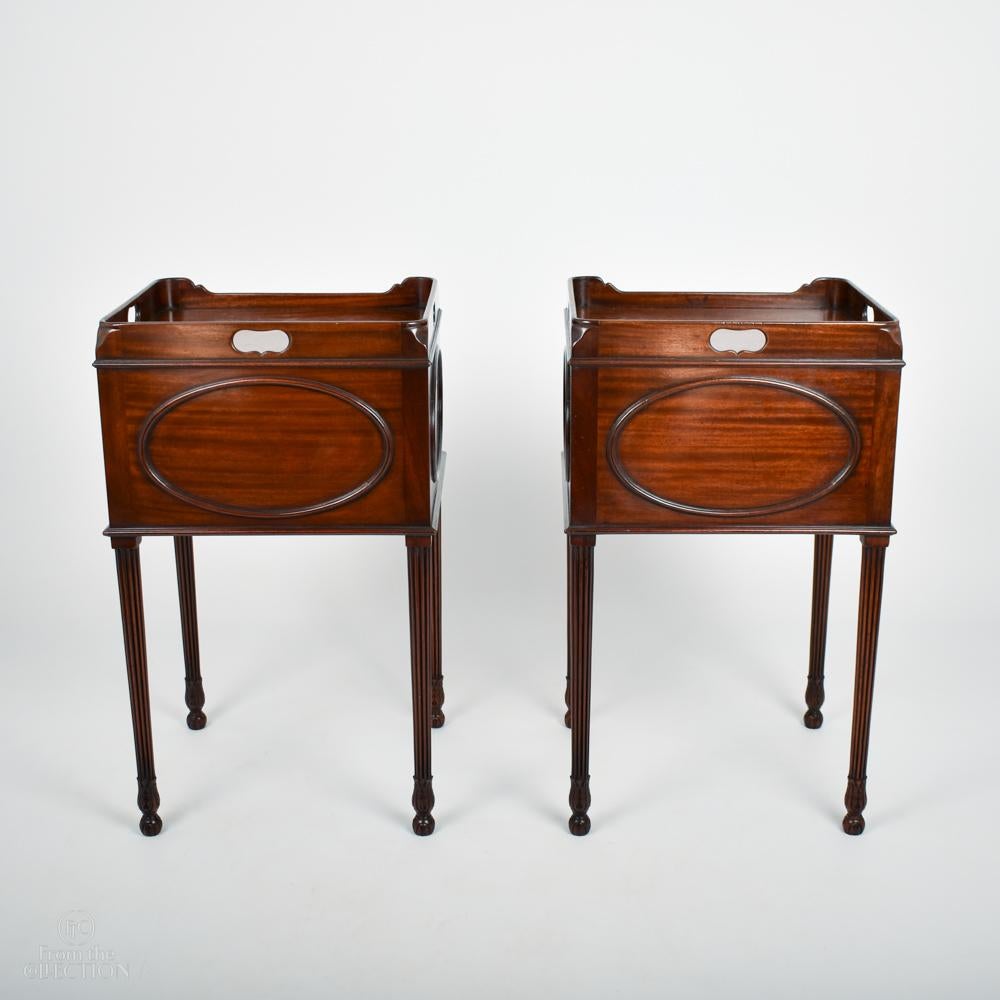 A Rich Mahogany pair of Georgian bedside pot tables circa. 1780 with exceptional colour and size. There are detailed oval panels to the sides and back. Fluted tapered legs on ball feet.