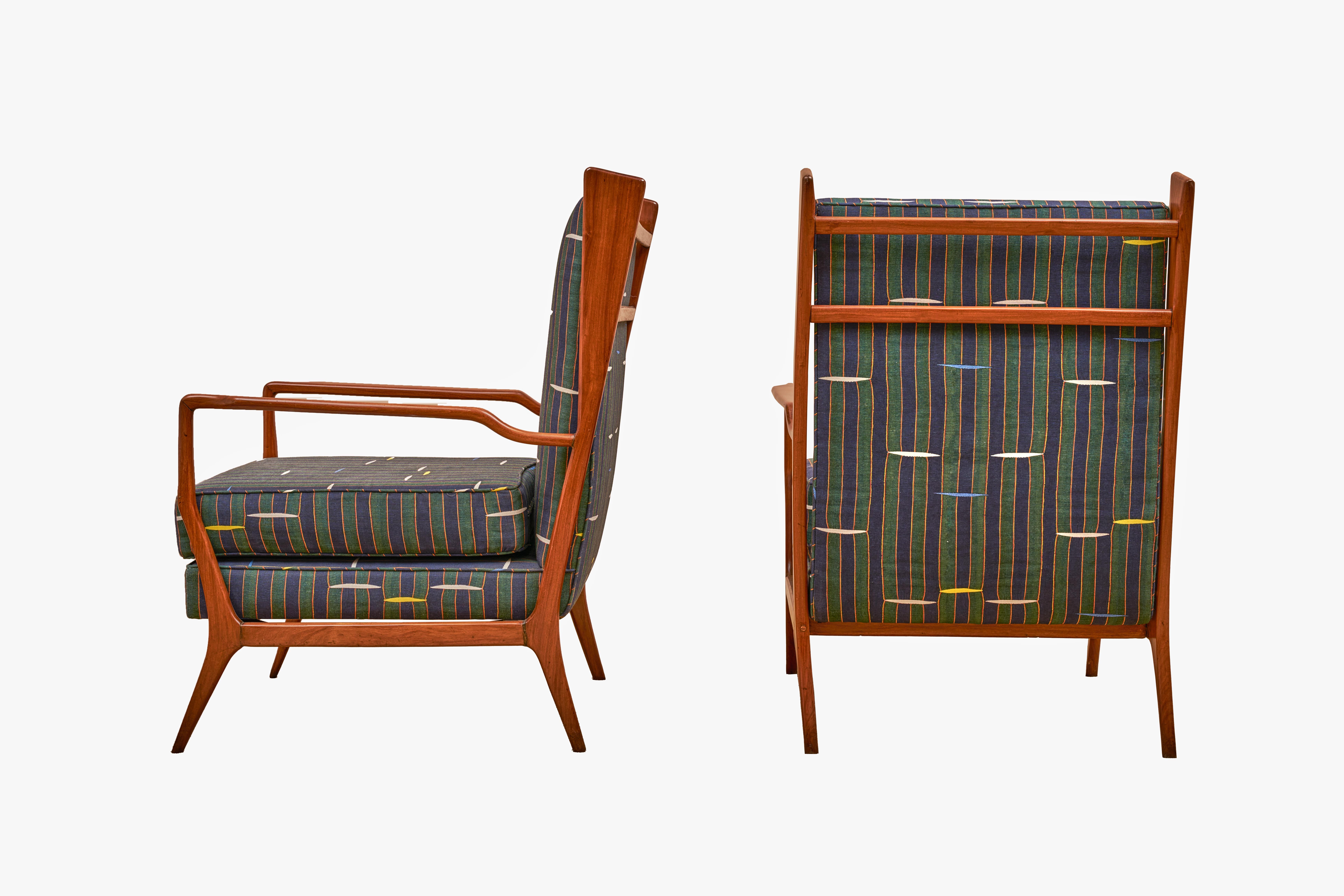 A remarkable pair of Rino Levi armchairs from the 1960s, newly upholstered in Jennifer Shorto fabric Blips and IFS, a mix of linen and cotton in a Panama weave with a design of vertical bars yoked by colorful dashes in lively blue and green. These