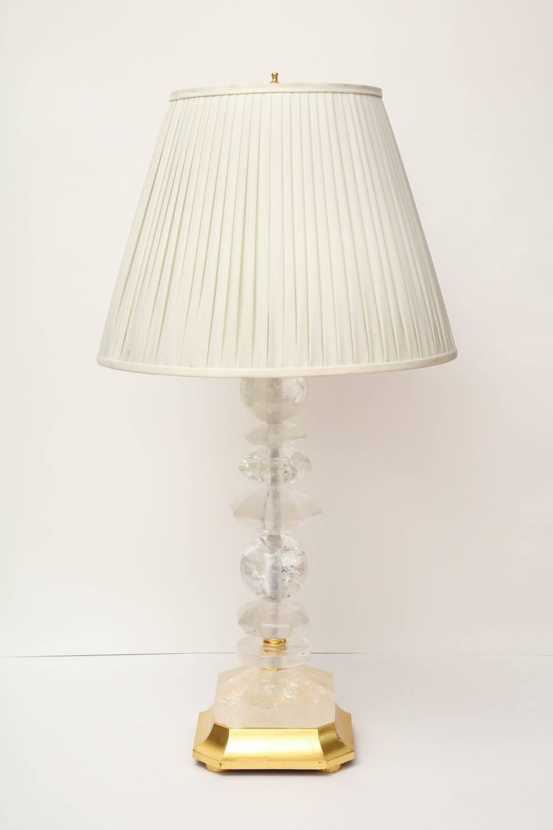 A pair of rock crystal table lamps, giltwood elements, wired for electricity, and fitted with two Edison sockets each, maximum wattage per socket: 100W.
 