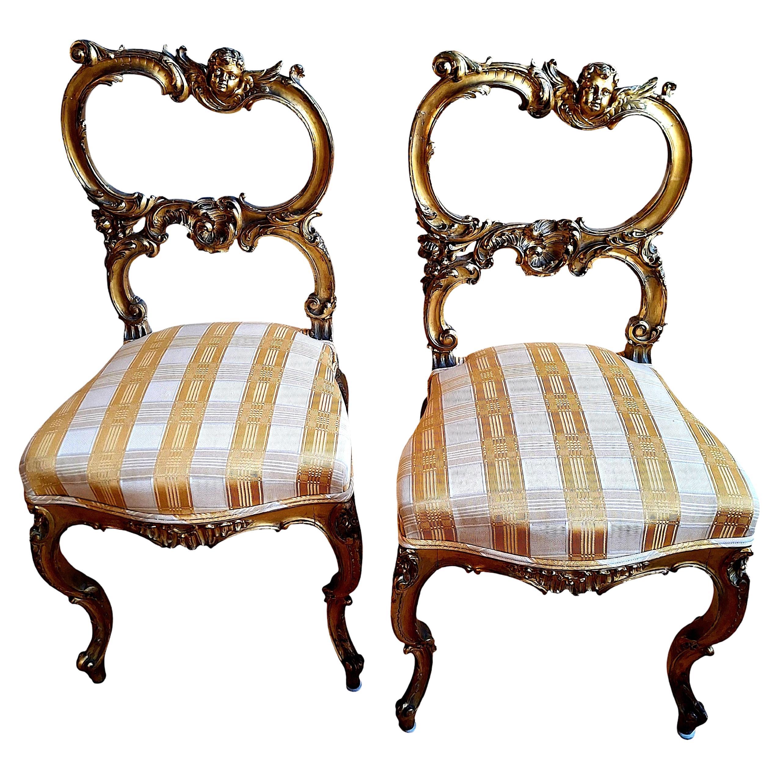 A Pair of Rococo-style, Gilded and Putti-adorned Side Chairs For Sale