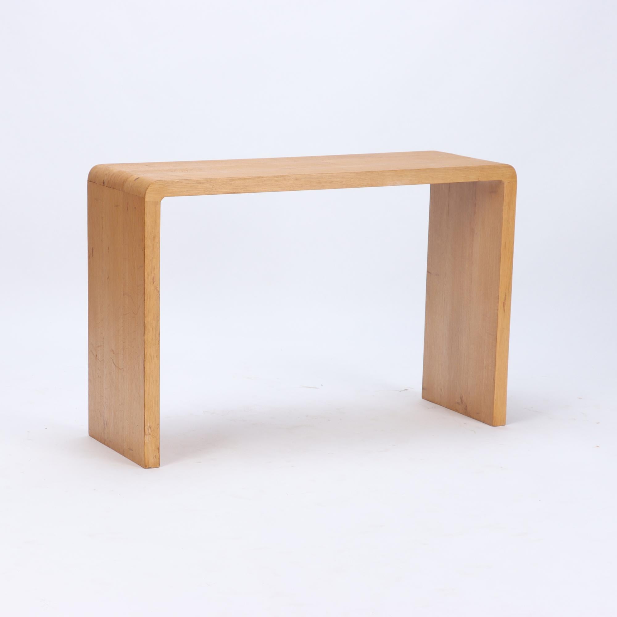 A pair of rounded cerused oak console tables. Contemporary.