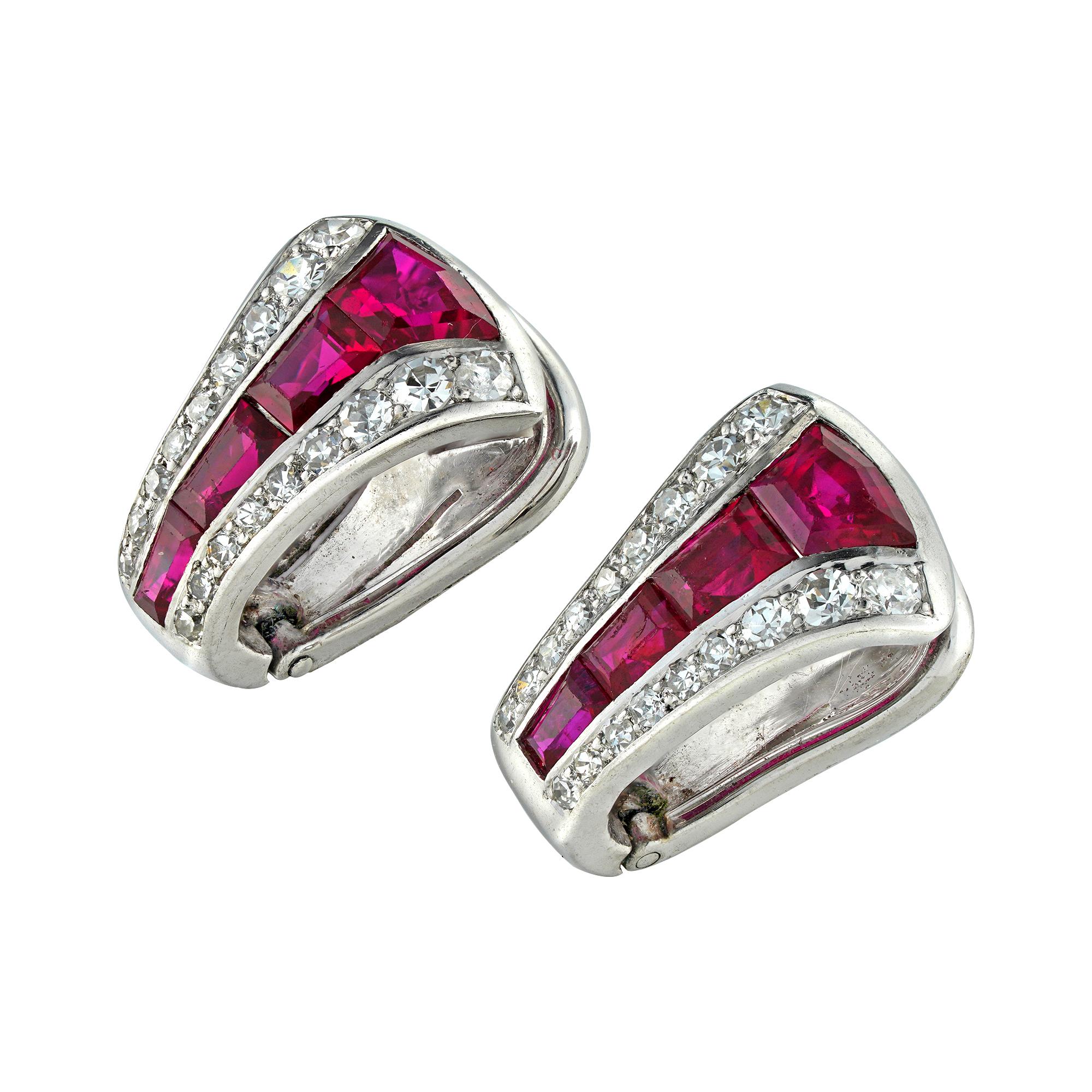 A pair of ruby and diamond clip earrings, each earring centrally-set with four trapeze-cut rubies graduating in size, set between two rows of nine graduating in size swiss-cut diamonds each, the eight rubies estimated to weigh 1.3 carats in total,