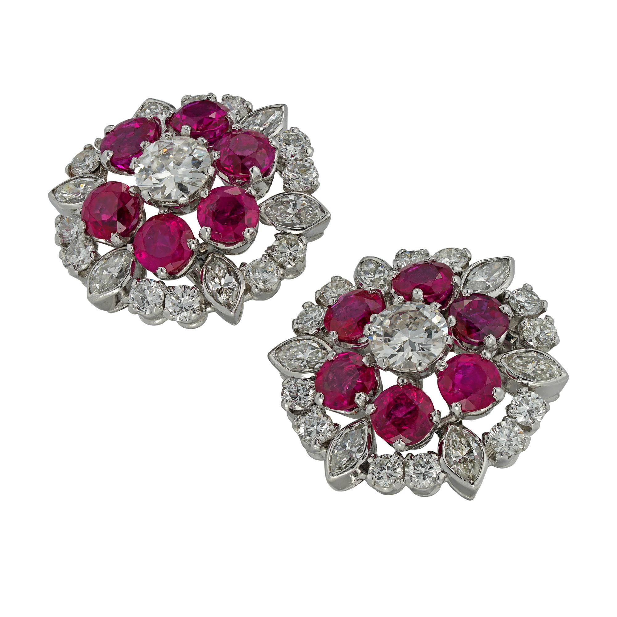 A pair of vintage ruby and diamond cluster earrings, each earing centrally-set with an old European-cut diamond estimated to weigh 0.55 carats, surrounded by six round faceted rubies, each estimated to weigh 0.3 carats, accompanied by GCS Report