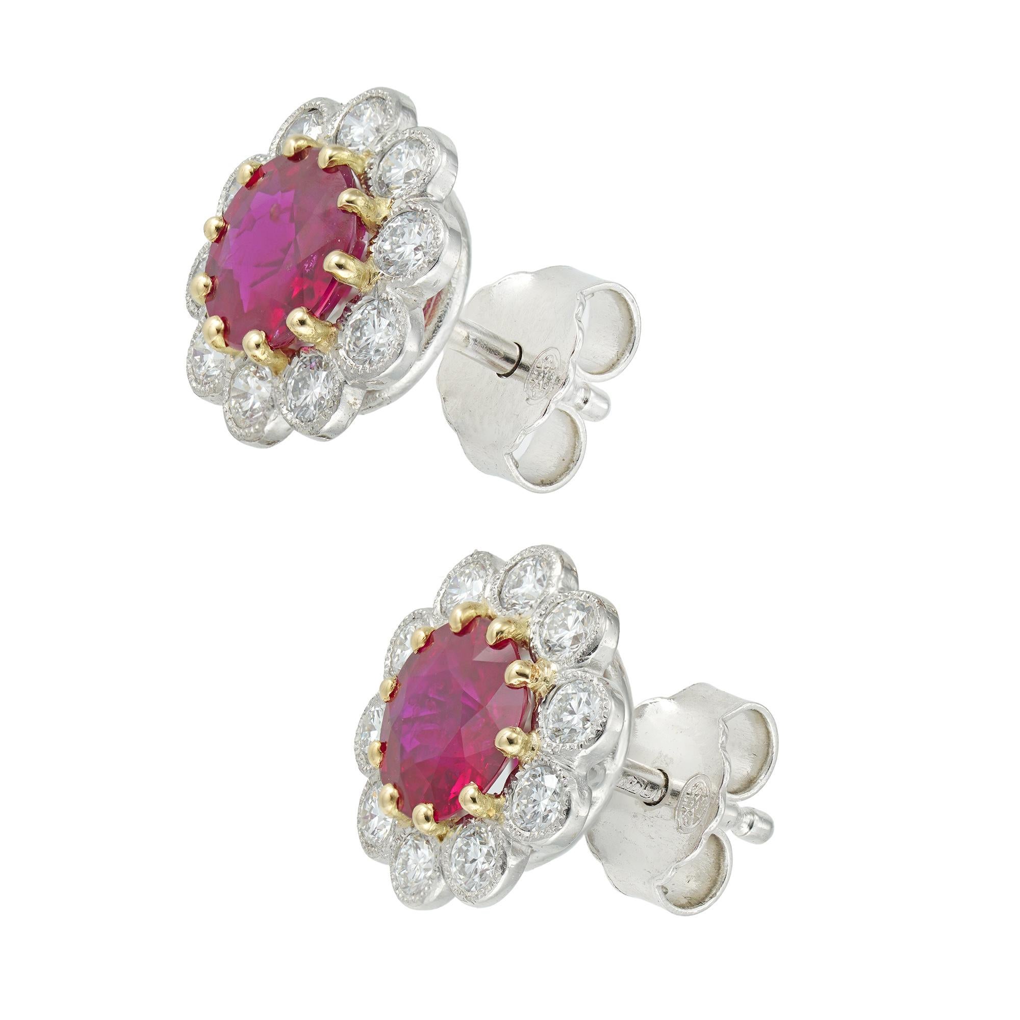 A pair of ruby and diamond cluster earrings, each earring in the form of a flower-head, centrally set with a round faceted emerald four claw-set in yellow gold, surrounded by ten platinum petals, each petal set with a round brilliant-cut diamond,