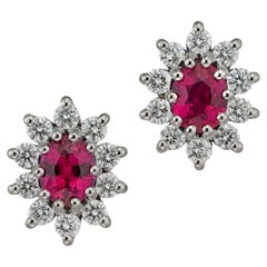 A pair of ruby and diamond cluster earrings